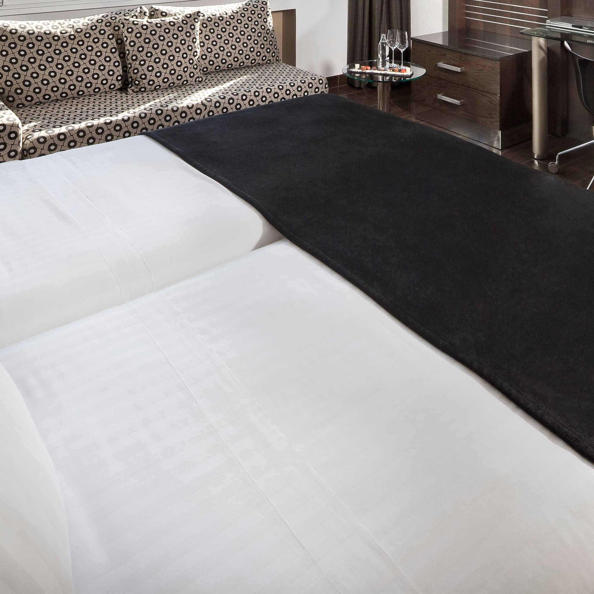 a bed with a black blanket on it