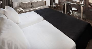 a bed with a black blanket on it