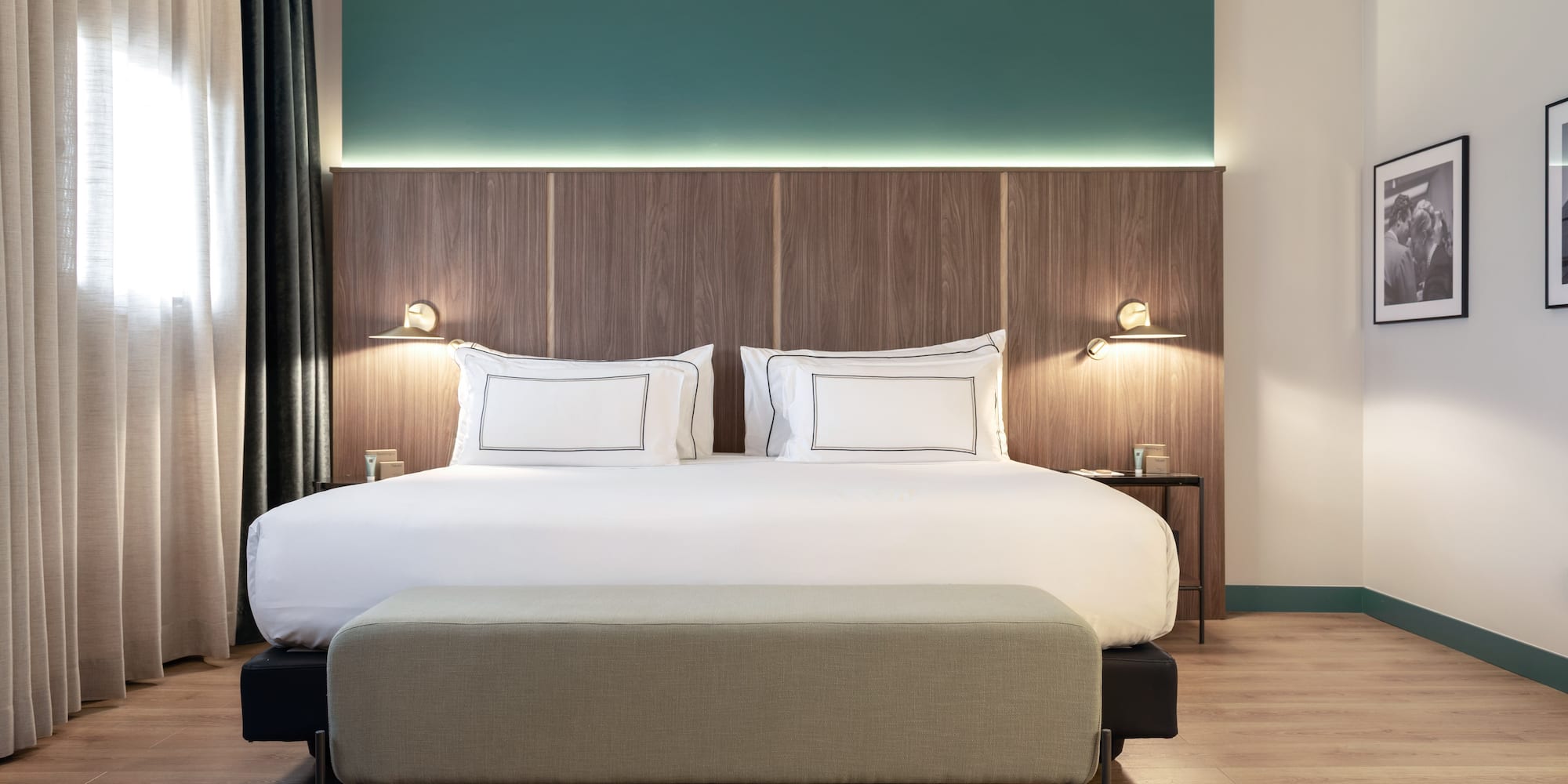 a bed with a bench and lamps