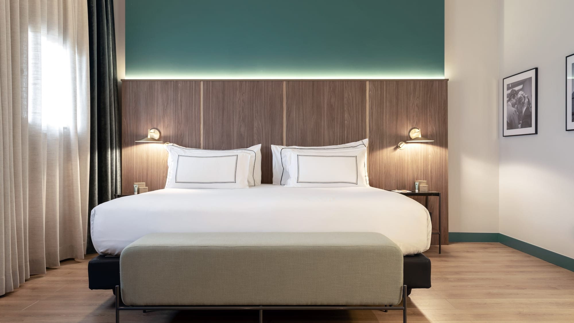 a bed with a bench and lamps