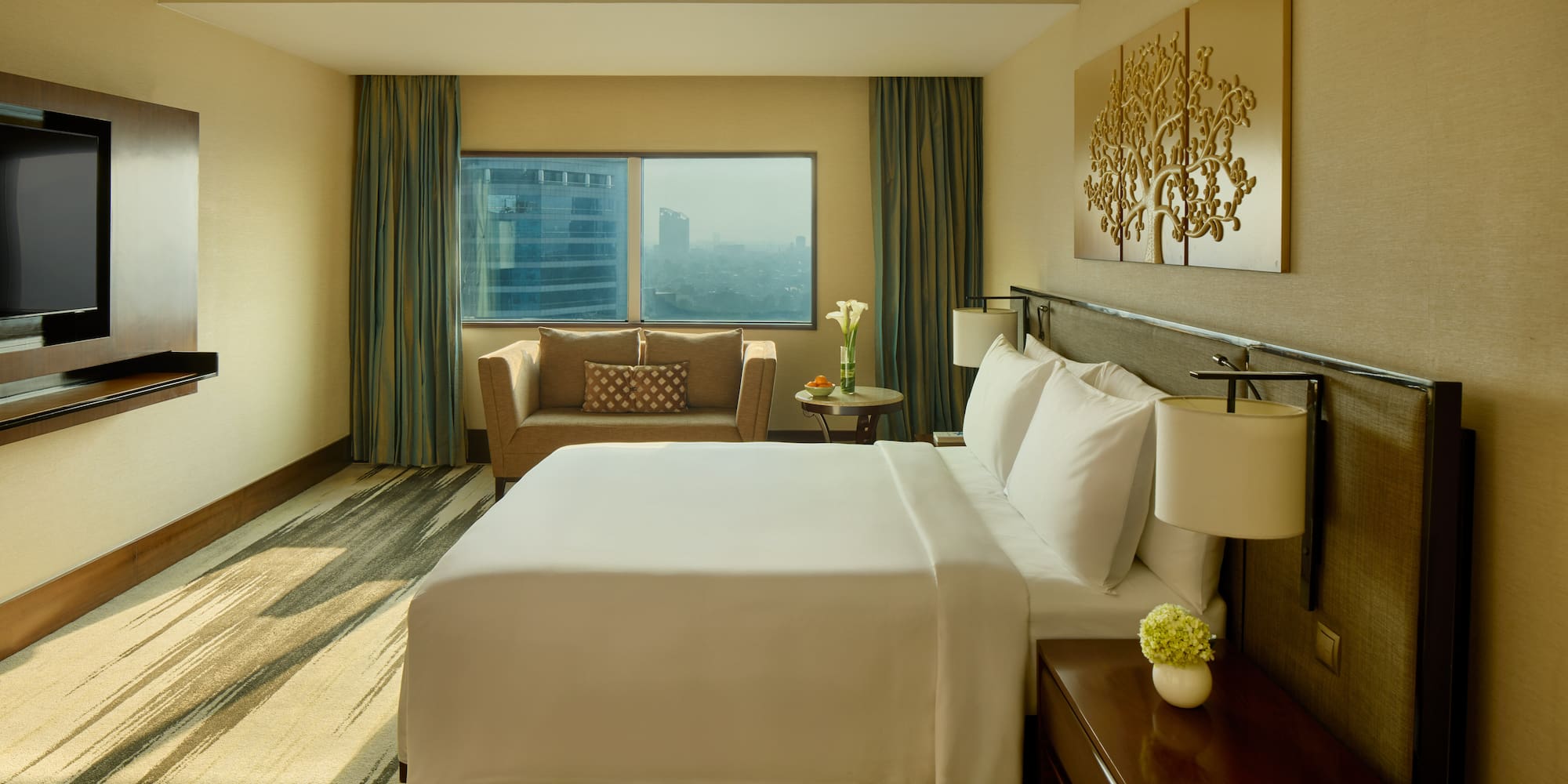 a hotel room with a bed and a chair