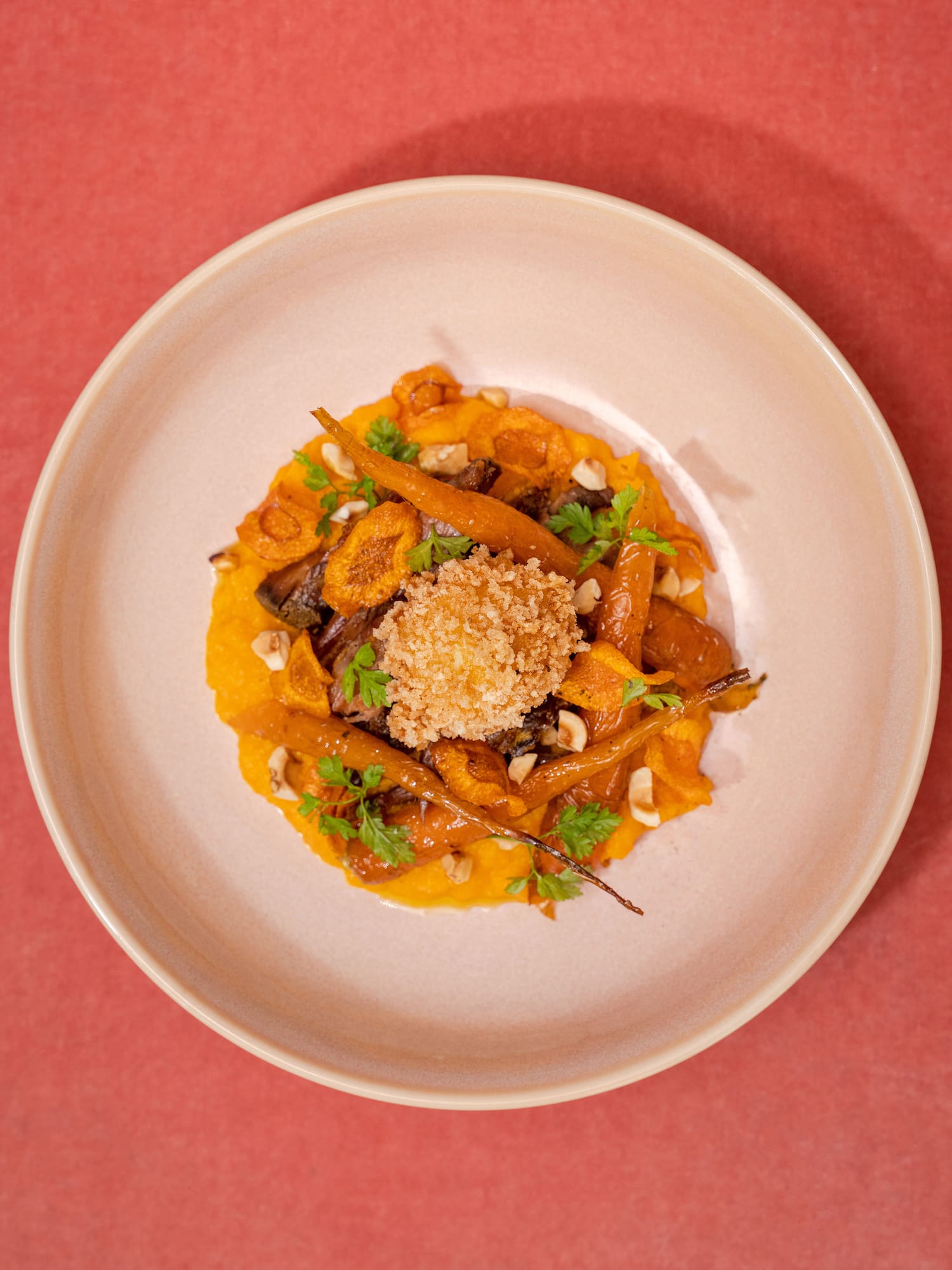 a plate of food on a red surface