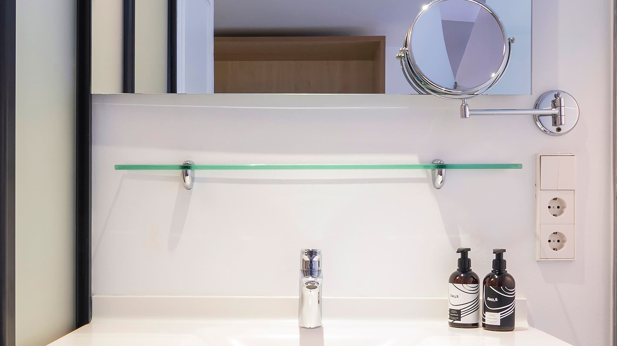 a bathroom sink with a mirror and a mirror