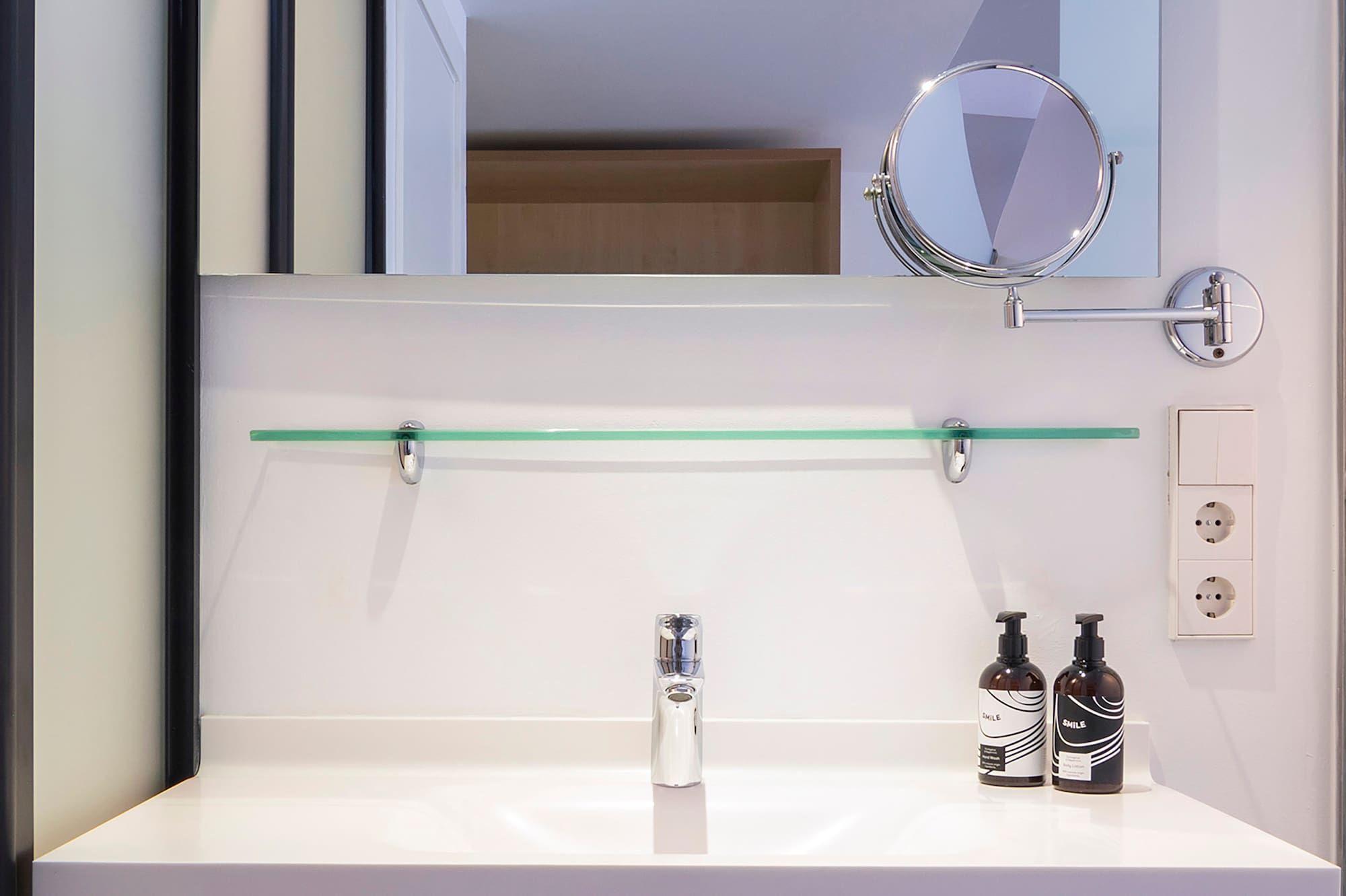 a bathroom sink with a mirror and a mirror