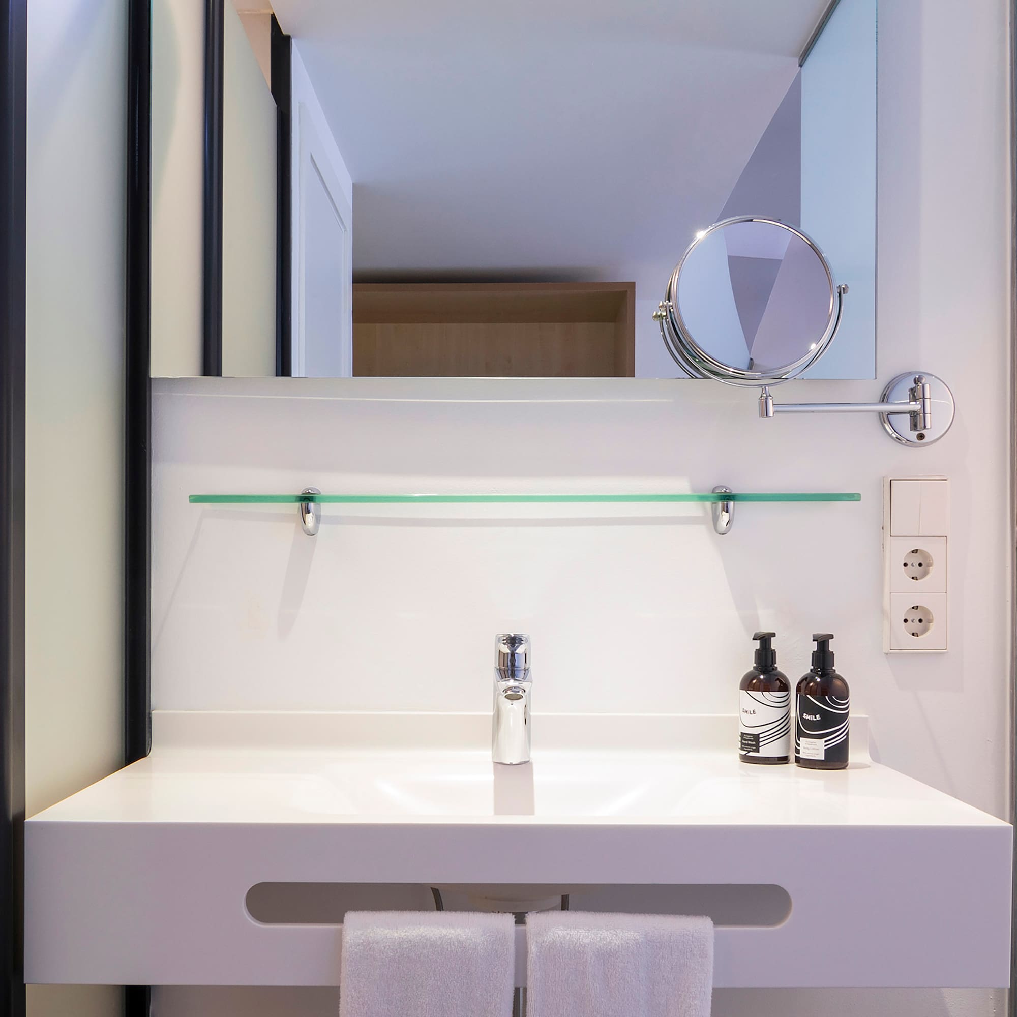 a bathroom sink with a mirror and a mirror