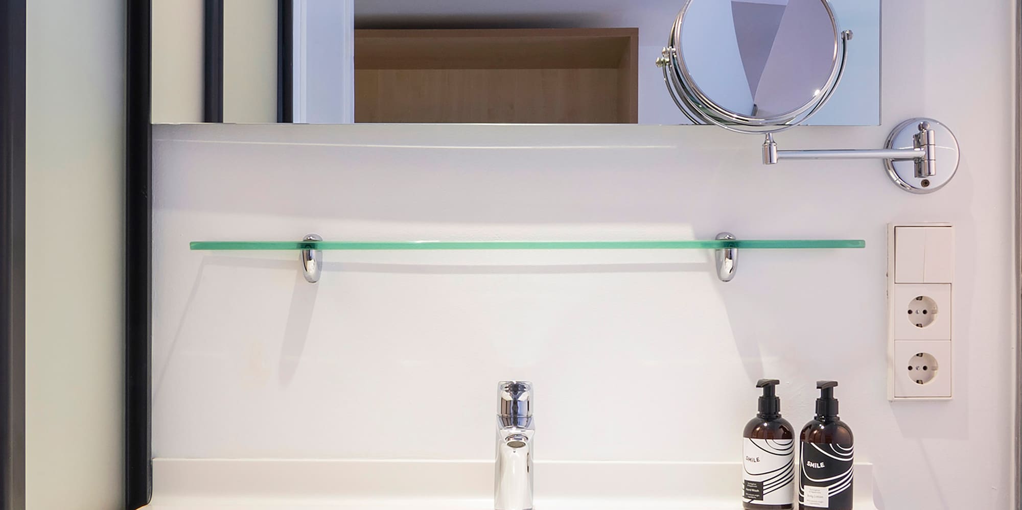 a bathroom sink with a mirror and a mirror