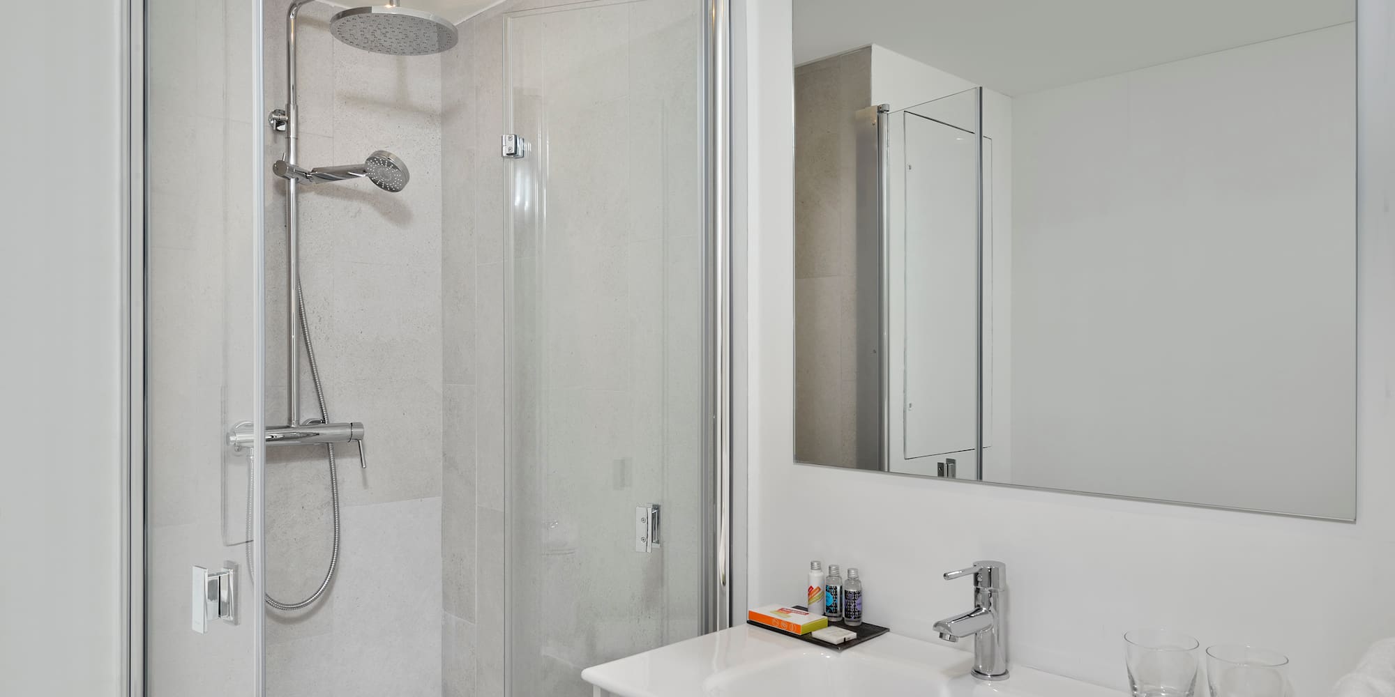 a bathroom with a shower and sink