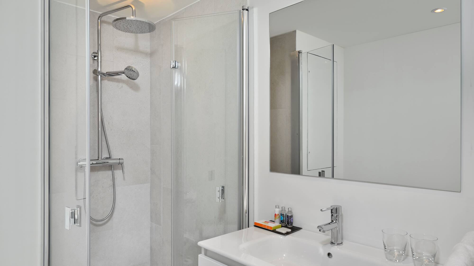 a bathroom with a shower and sink