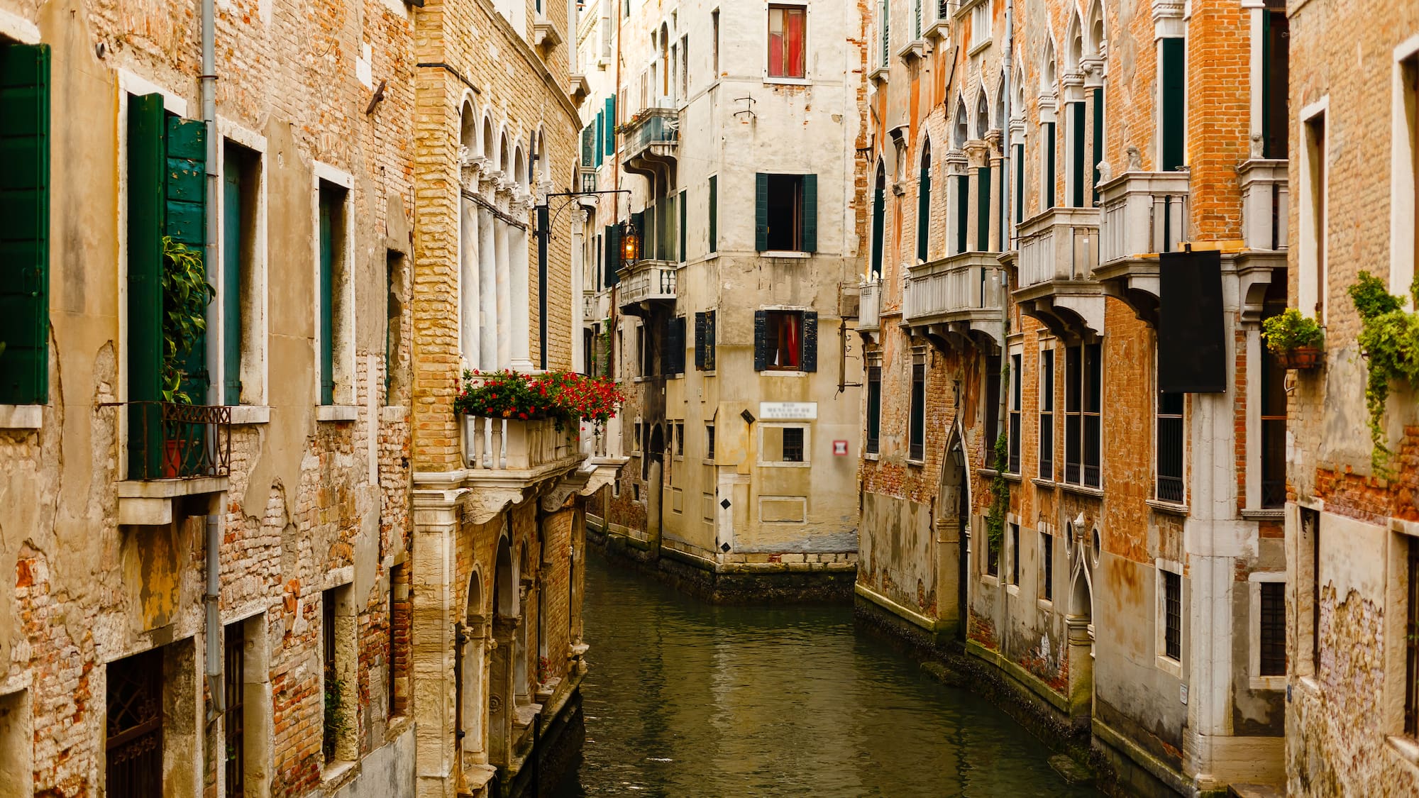 a canal between buildings with windows