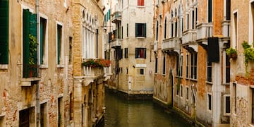 a canal between buildings with windows