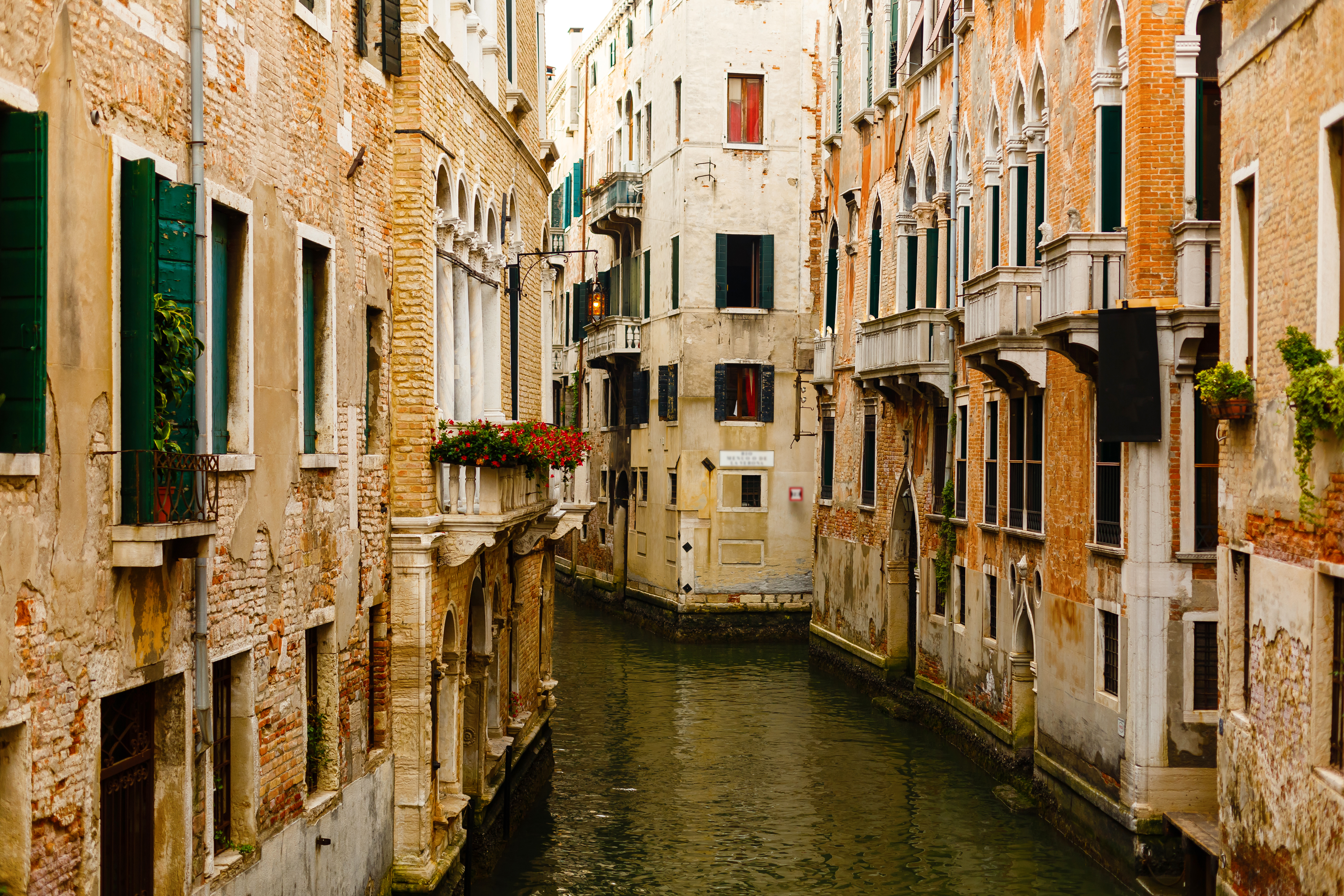 a canal between buildings with windows