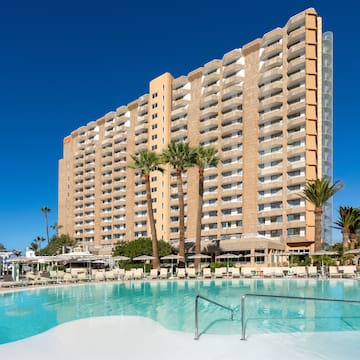 a large building with a pool in front of it