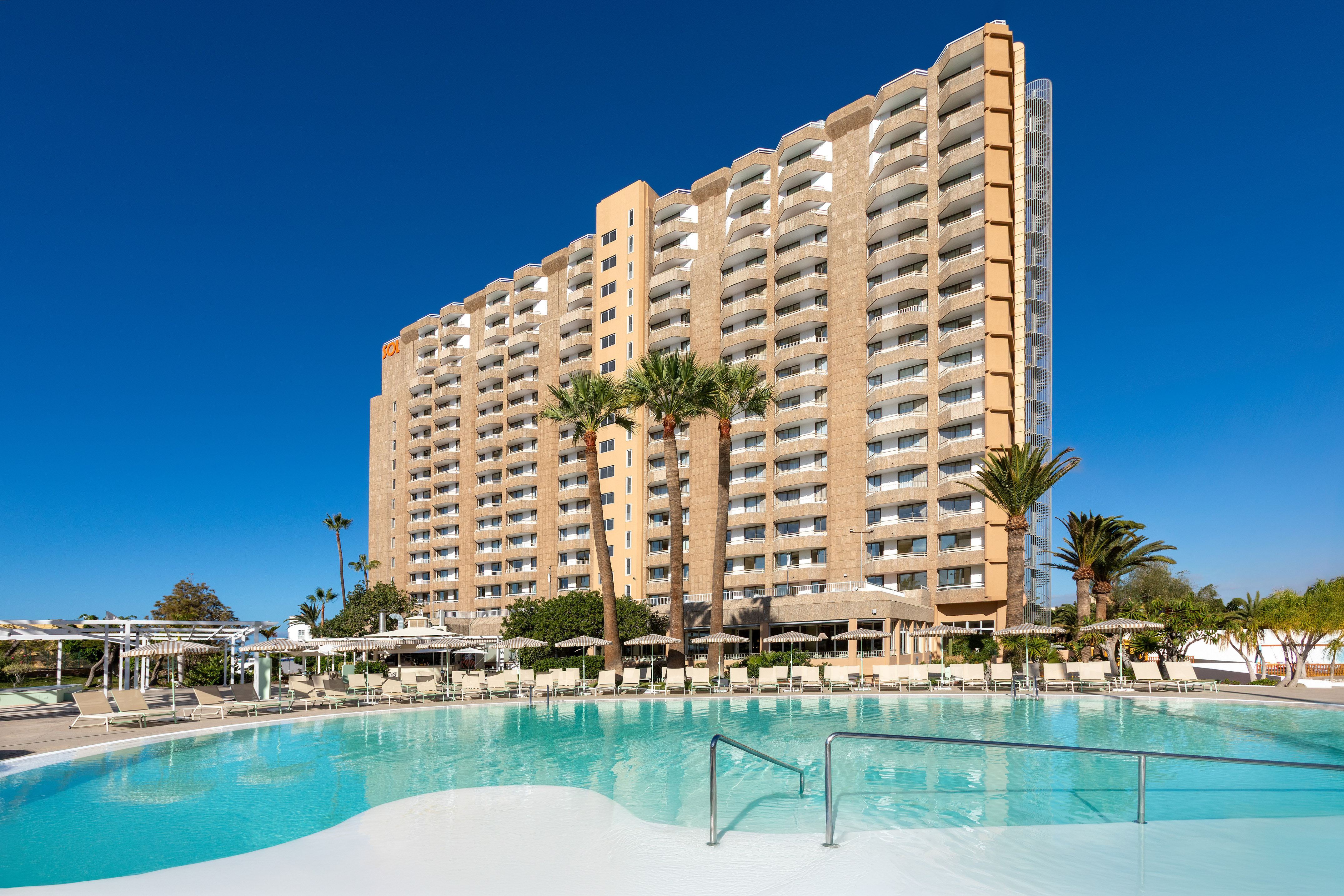 a large building with a pool in front of it