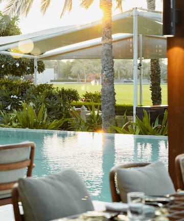a pool with a table and chairs
