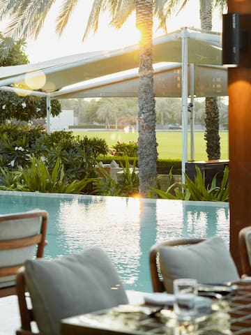 a pool with a table and chairs
