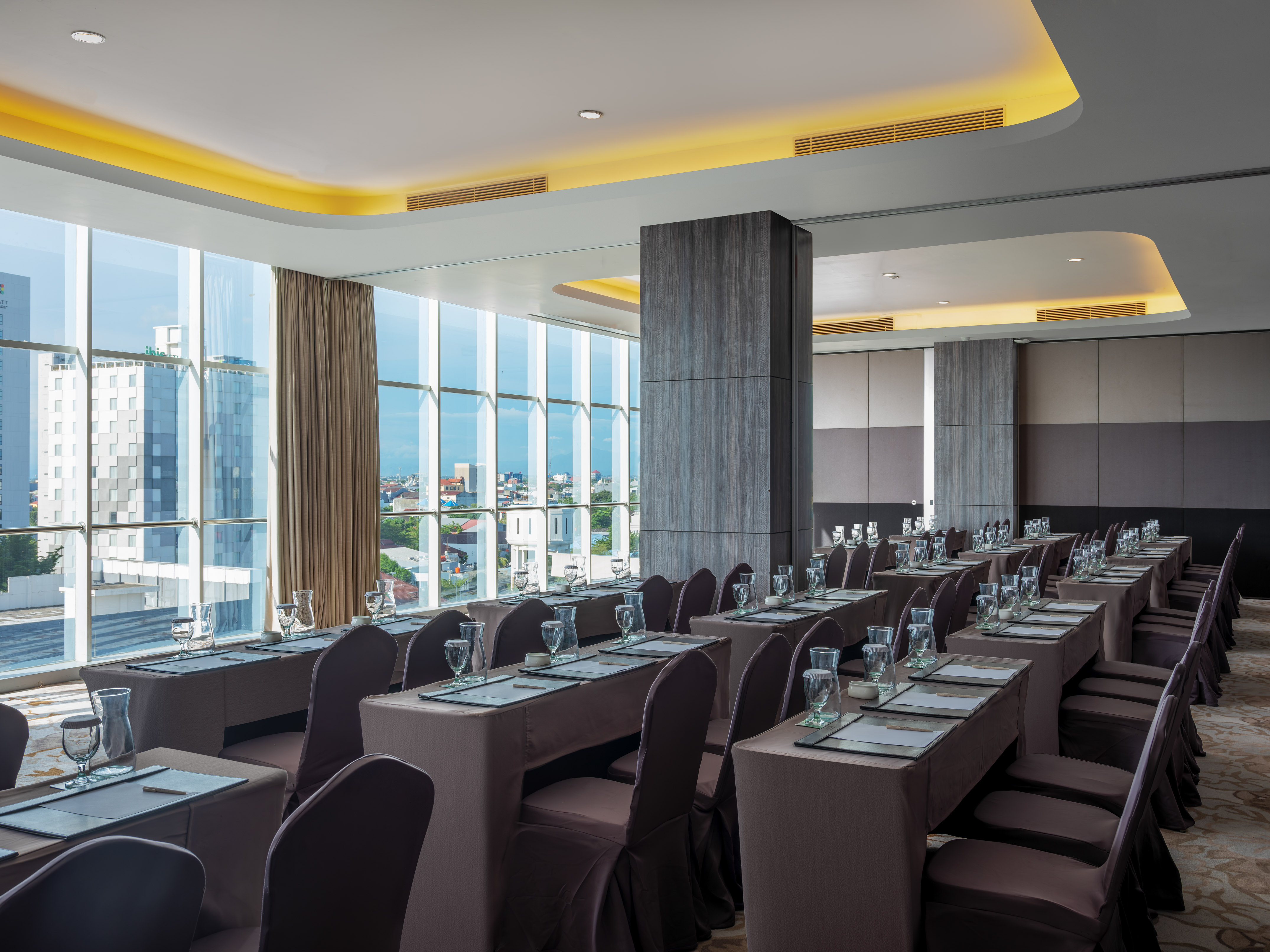 Modern conference room with city view, classroom setup, and elegant lighting.