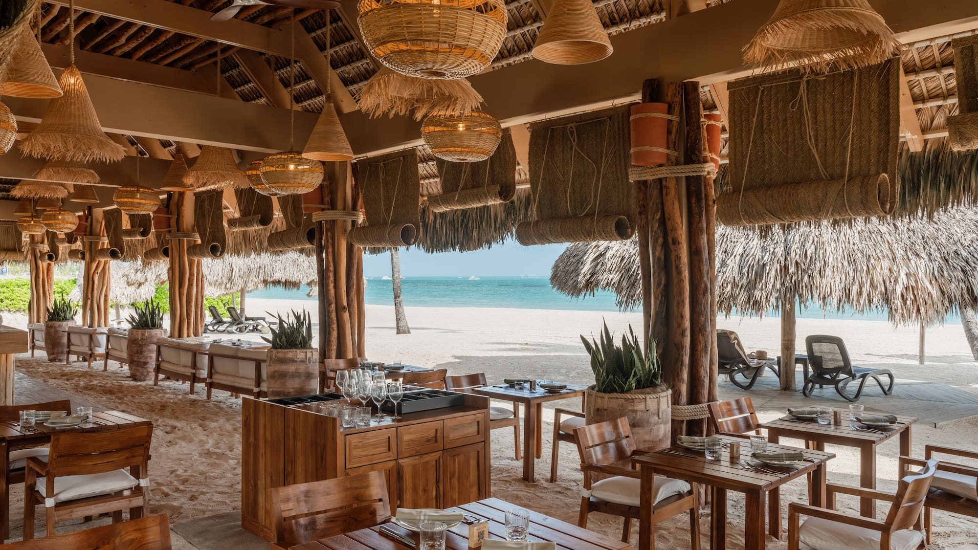 a restaurant with tables and chairs on a beach