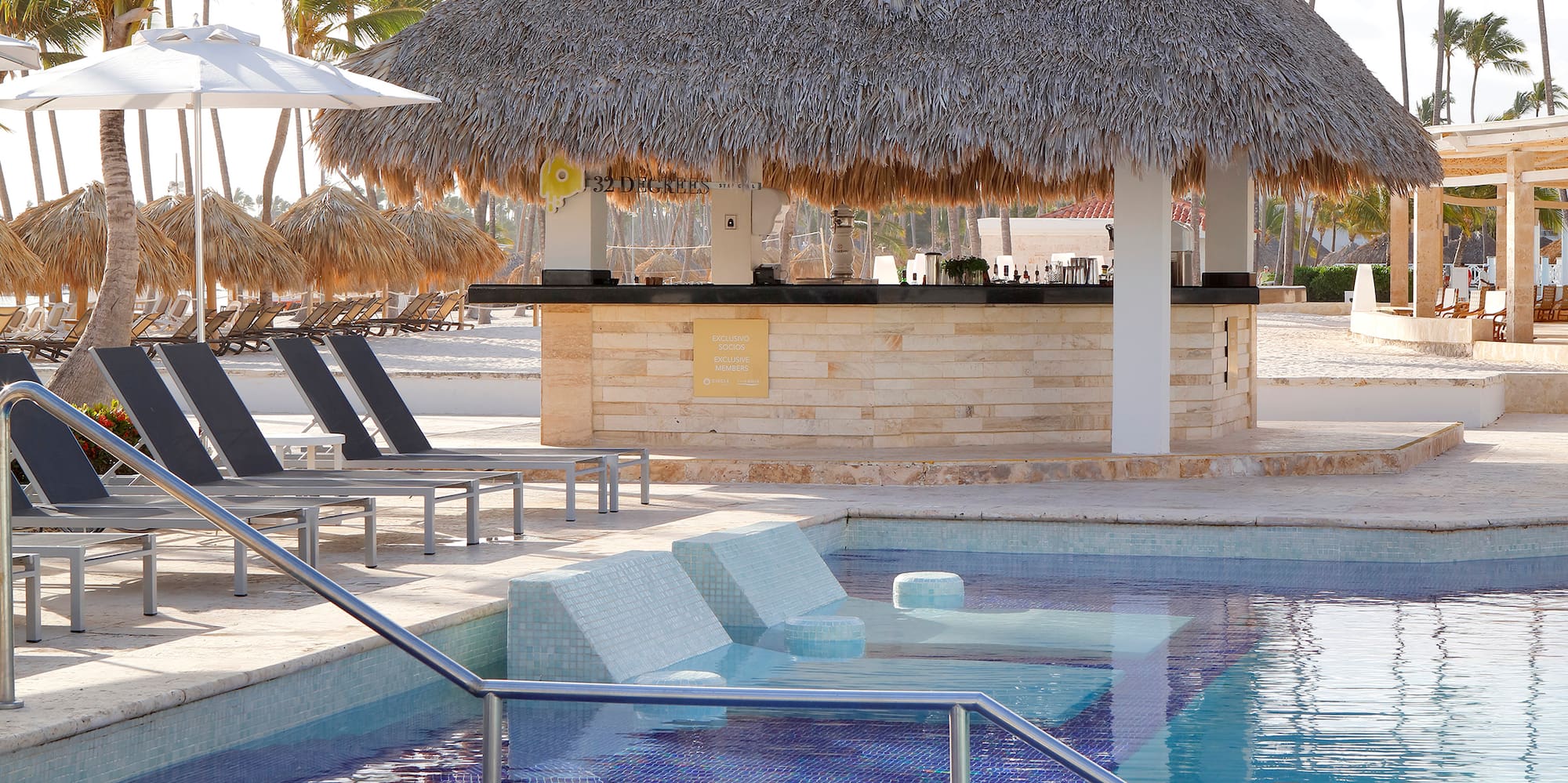 a pool with a bar and chairs
