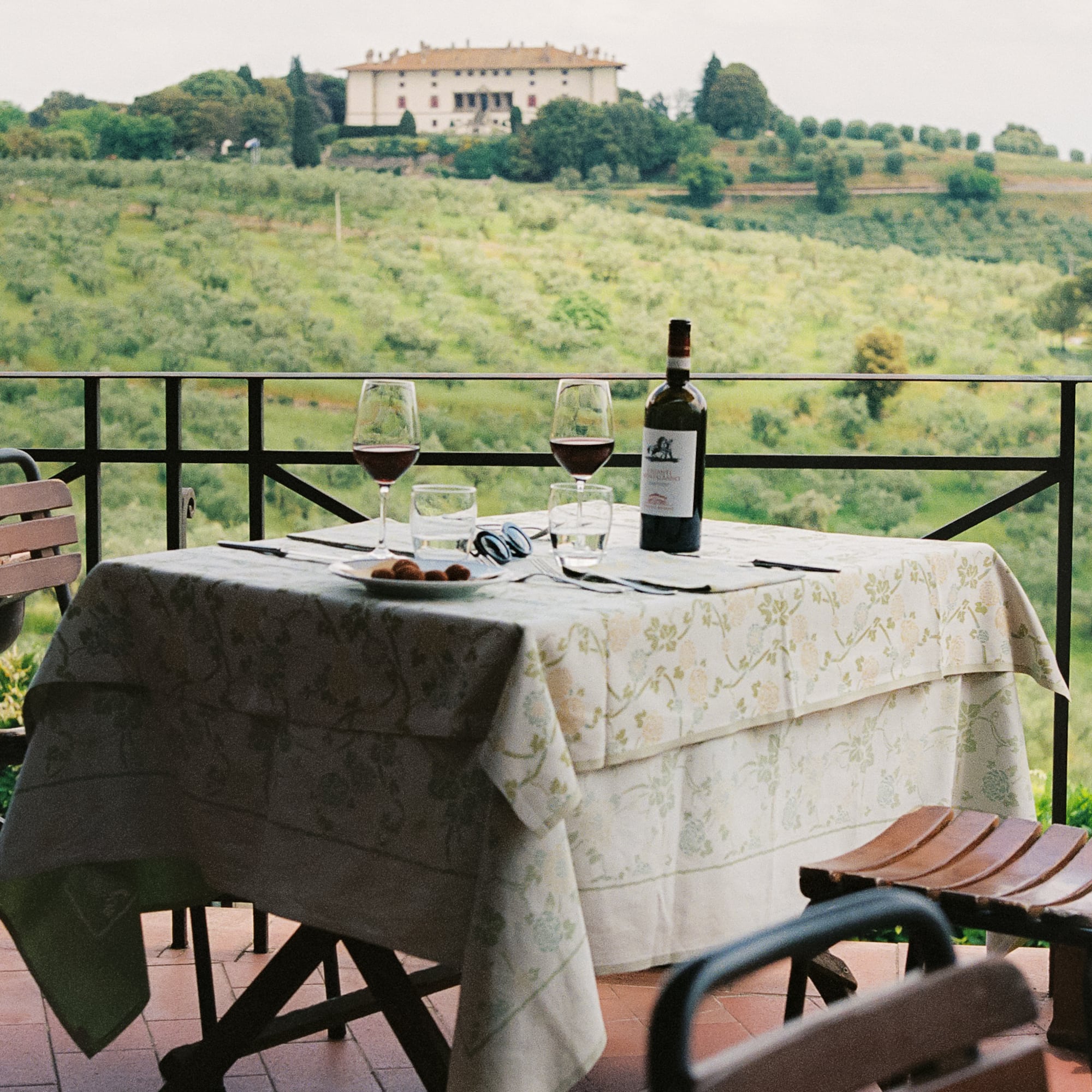 a table with wine glasses and a bottle on it