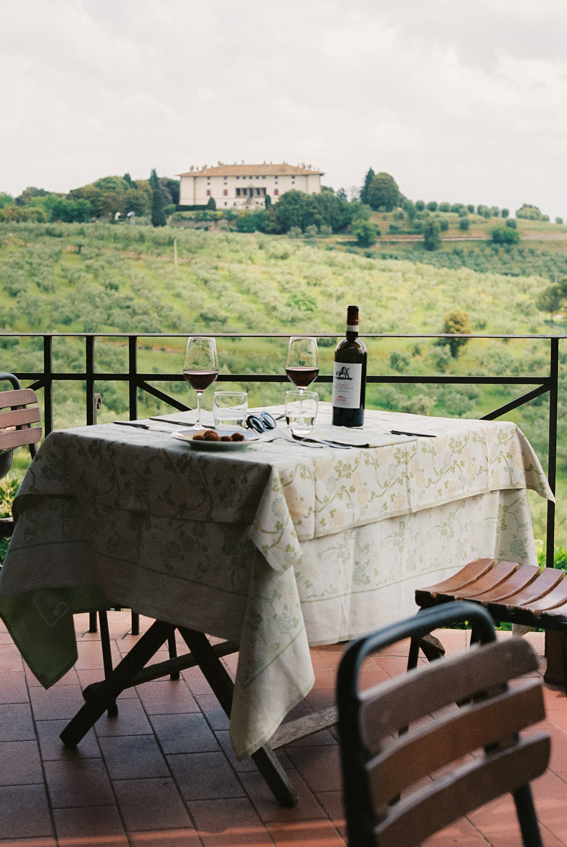 a table with wine glasses and a bottle on it
