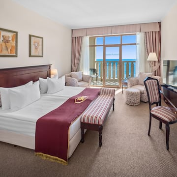 a hotel room with a piano and a bed