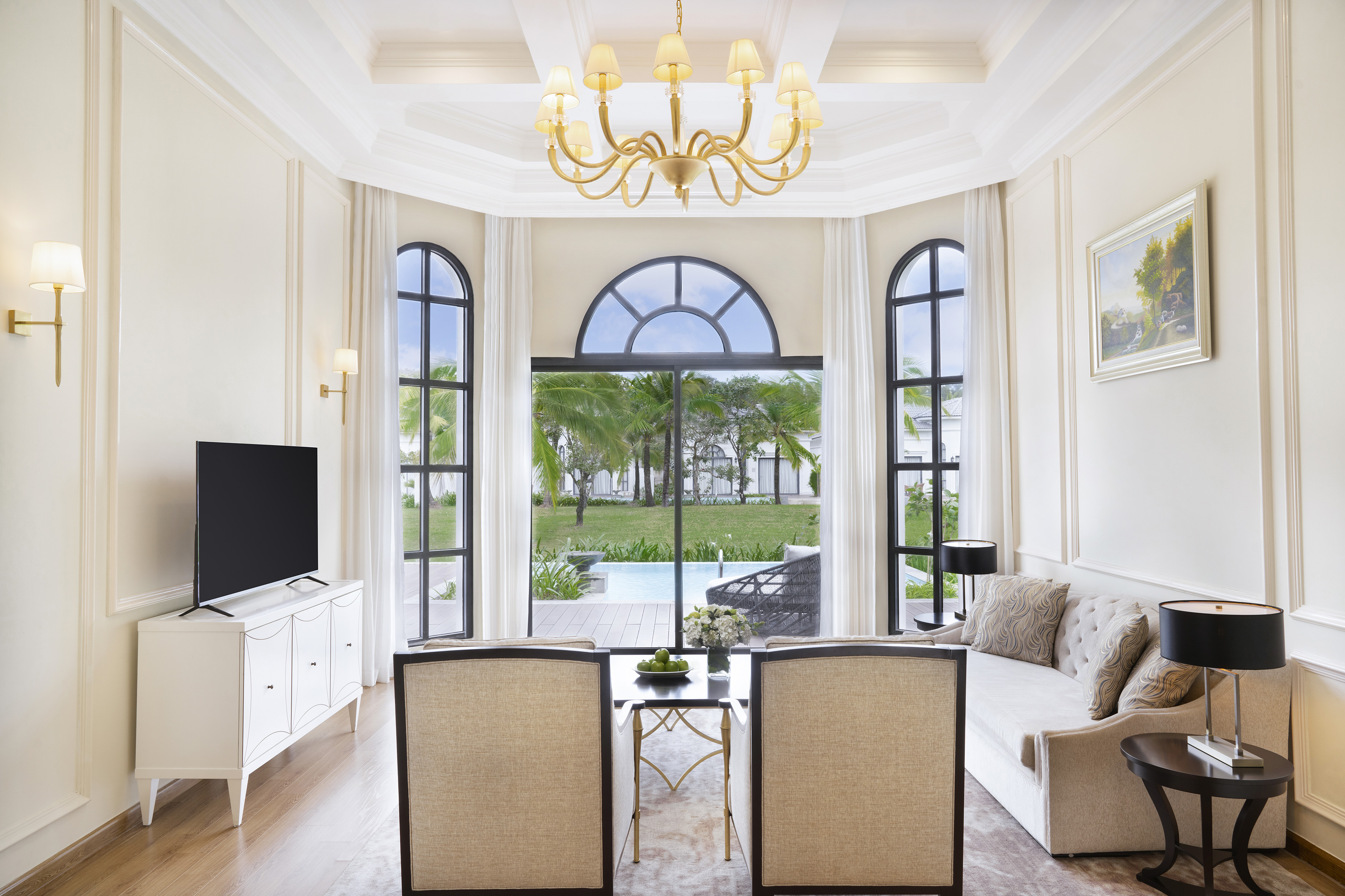 Chic resort living room with private pool and tropical garden view.
