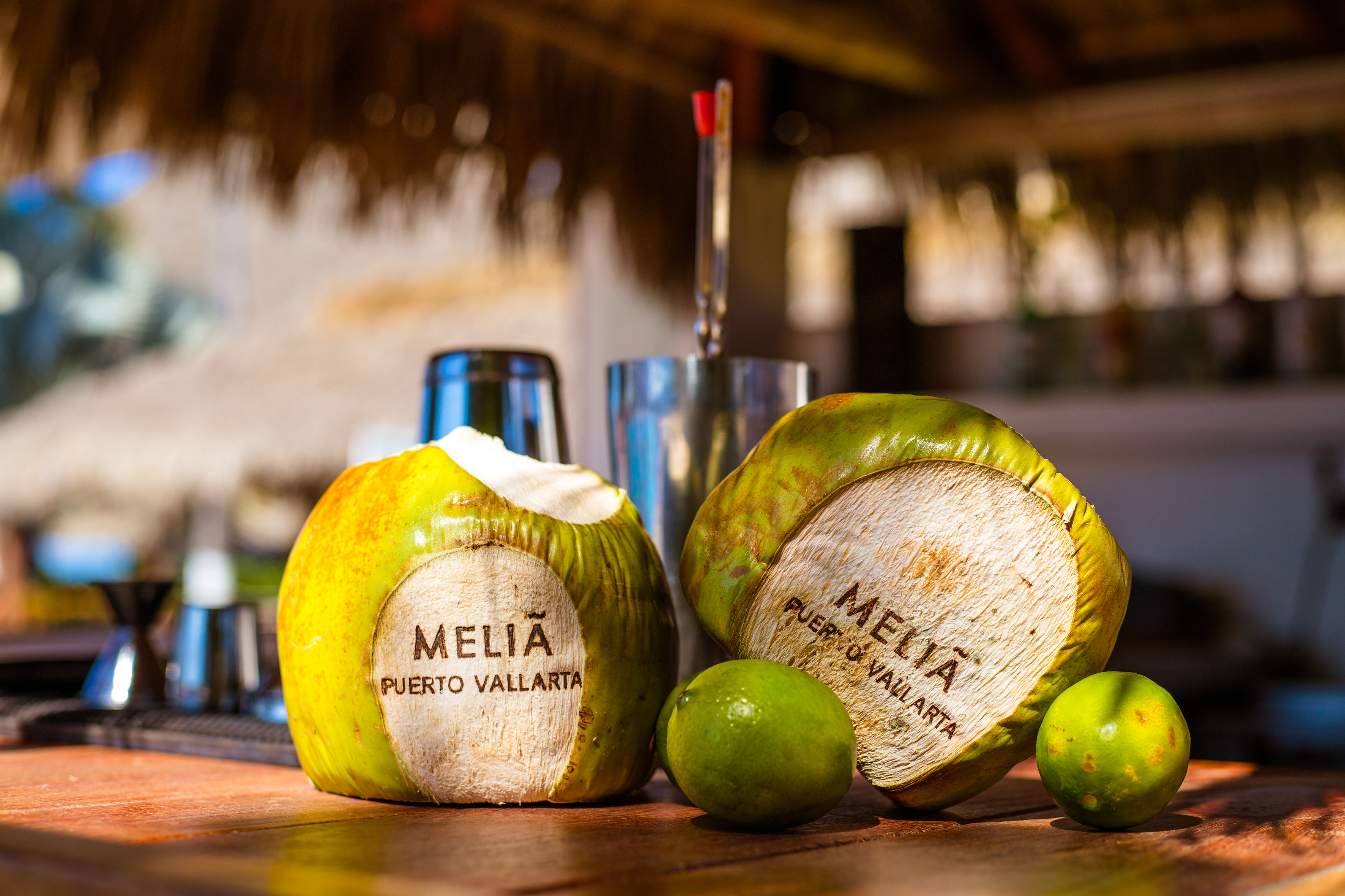 Melia Puerto Vallarta branded coconuts and limes on a tropical resort bar.