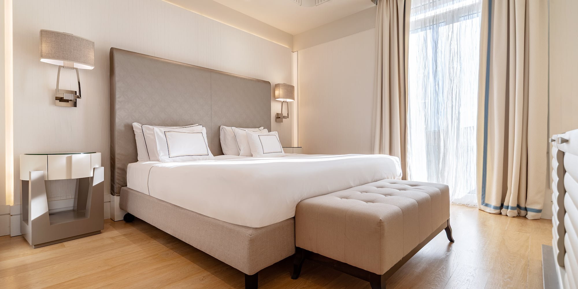 a bed with a foot board and a bench in a room