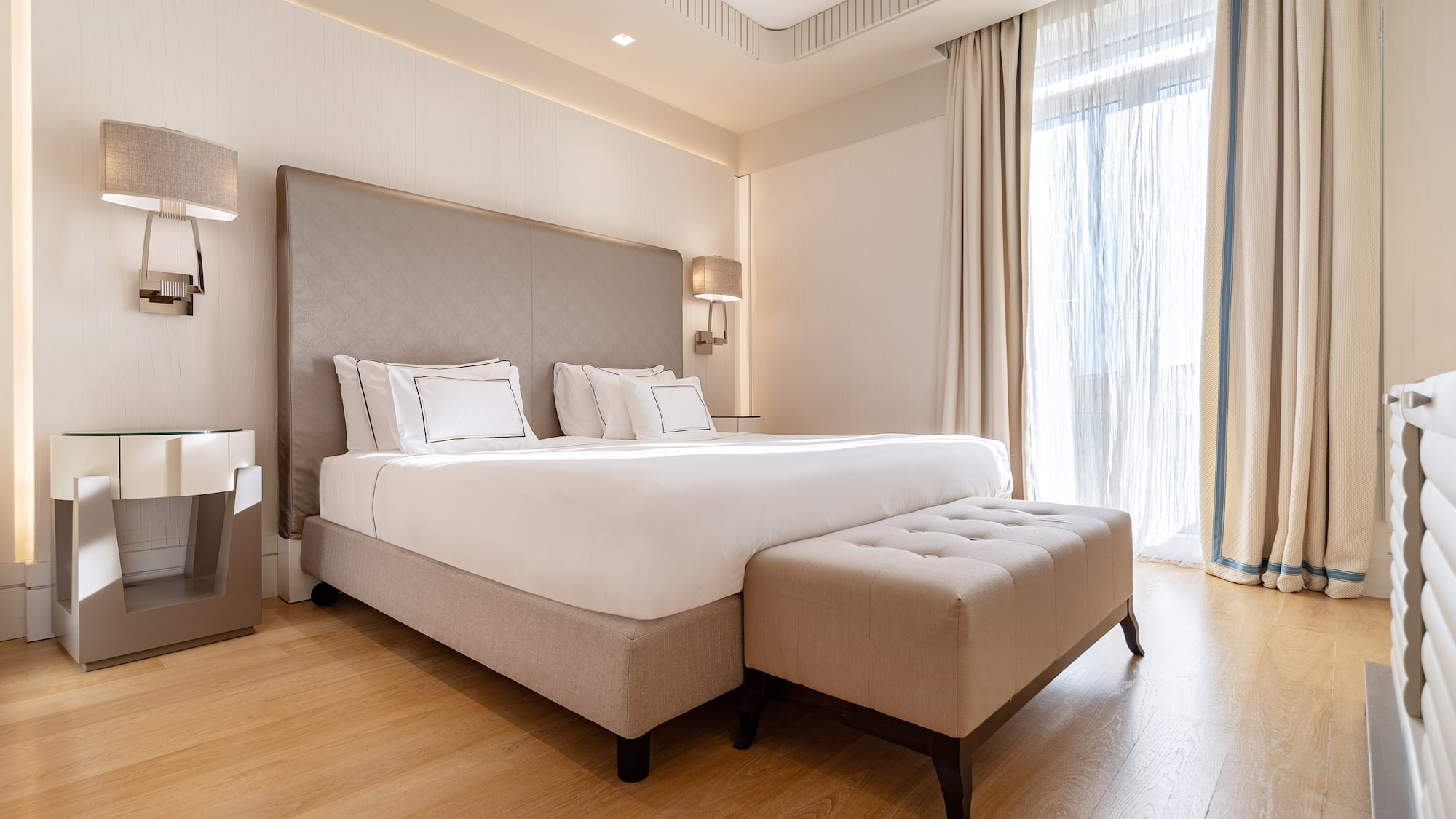 a bed with a foot board and a bench in a room