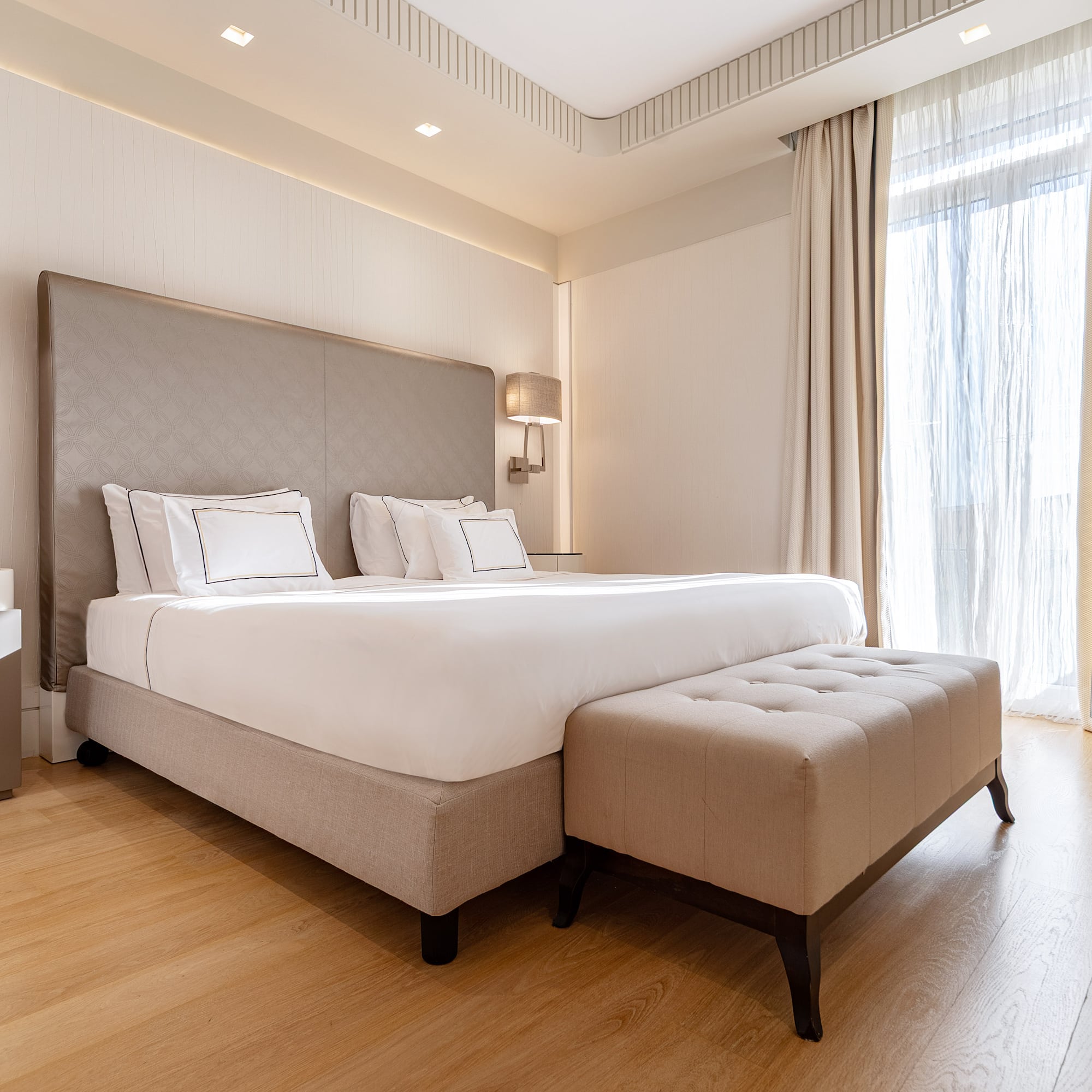 a bed with a foot board and a bench in a room