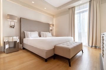a bed with a foot board and a bench in a room