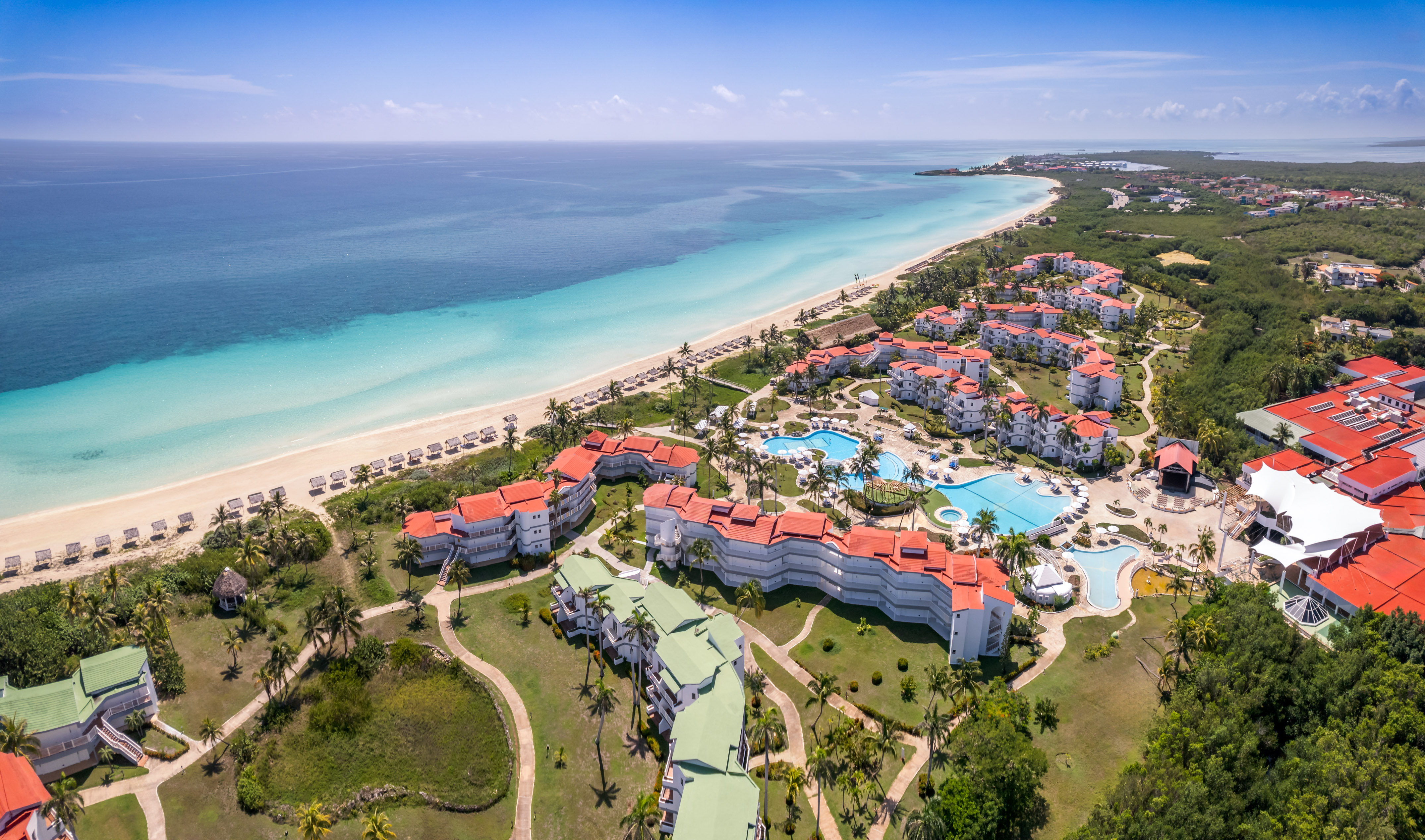 a resort with a pool and a beach