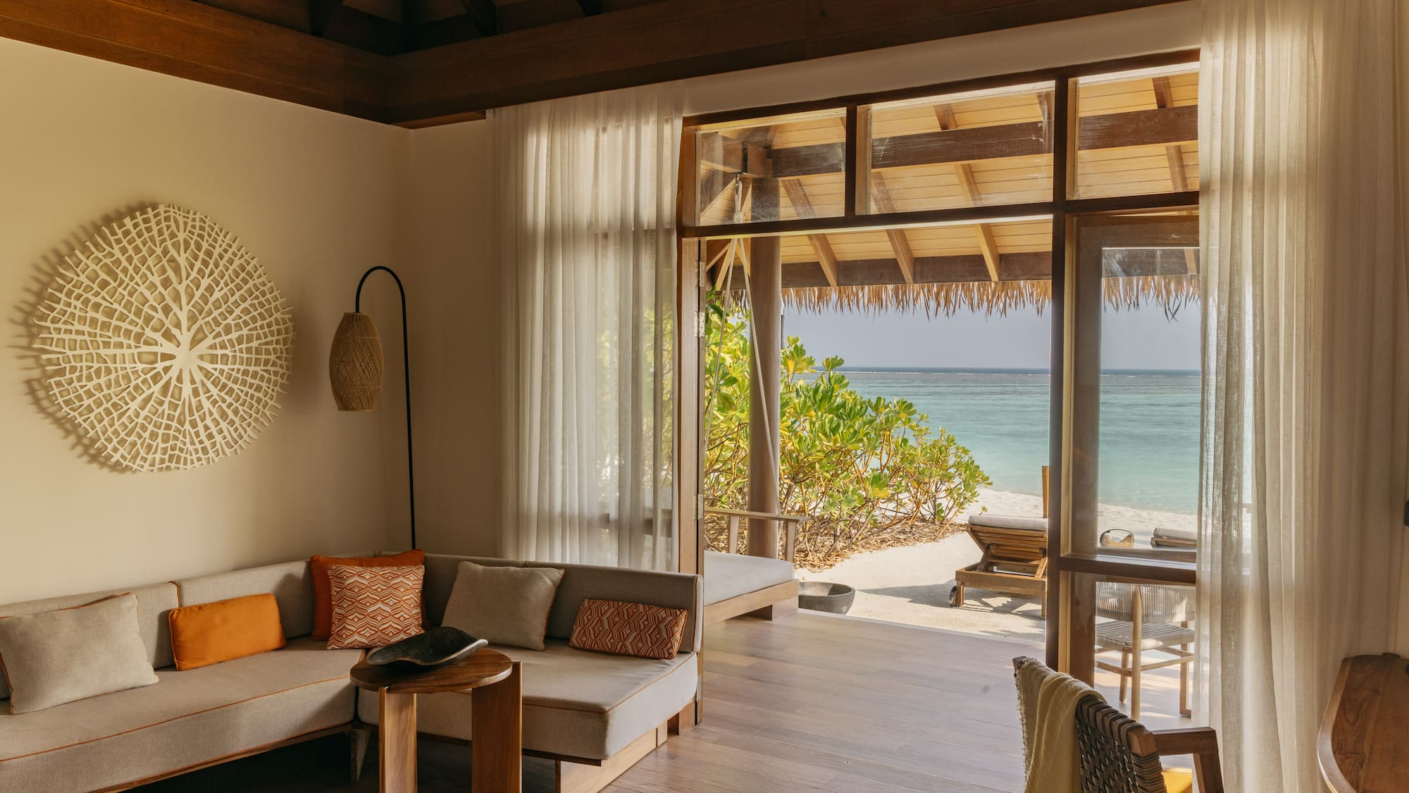 a room with a bed and chairs