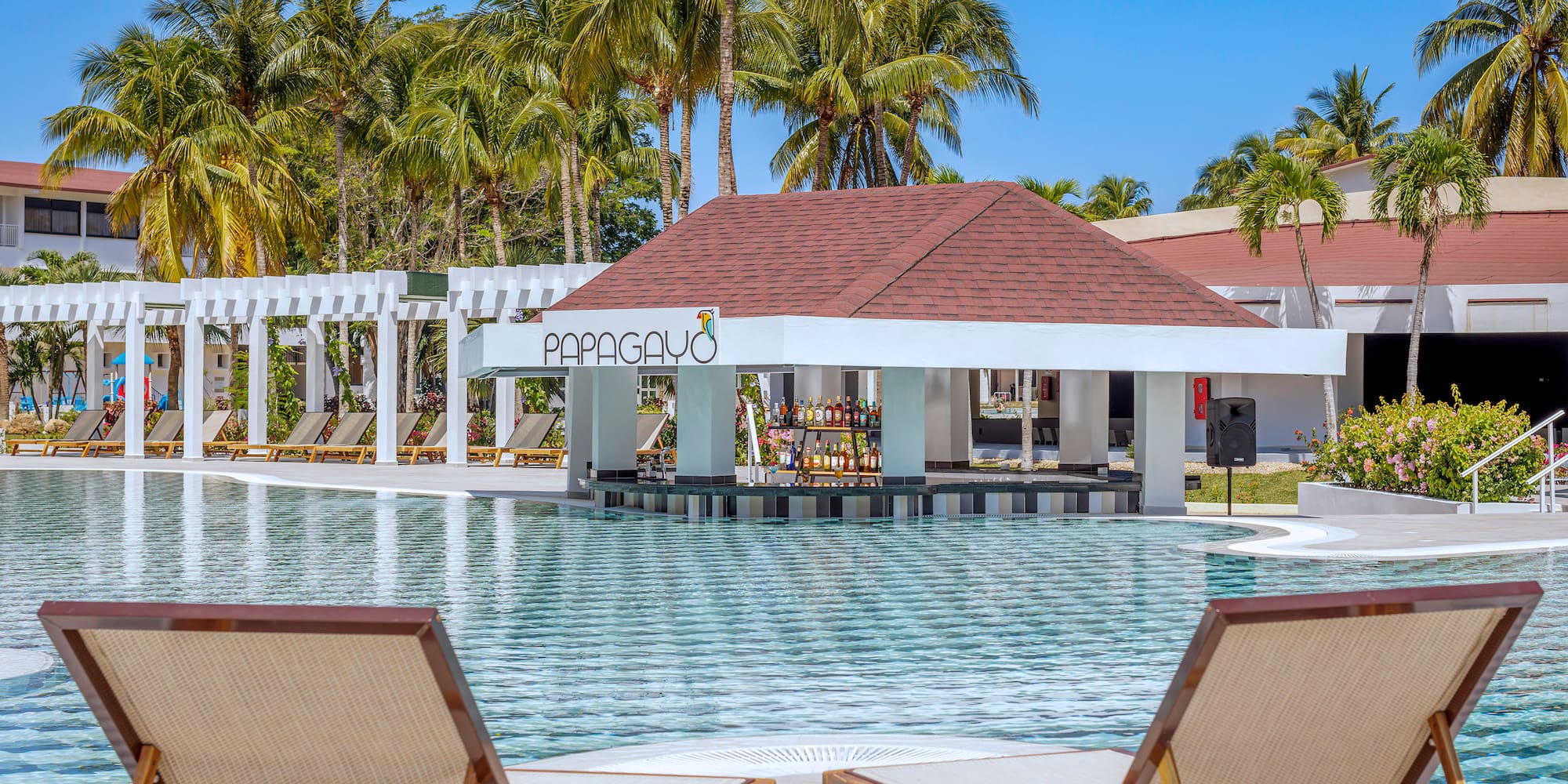 a pool with lounge chairs and a bar