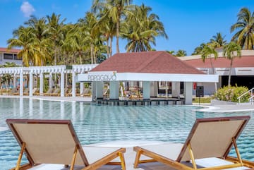a pool with lounge chairs and a bar