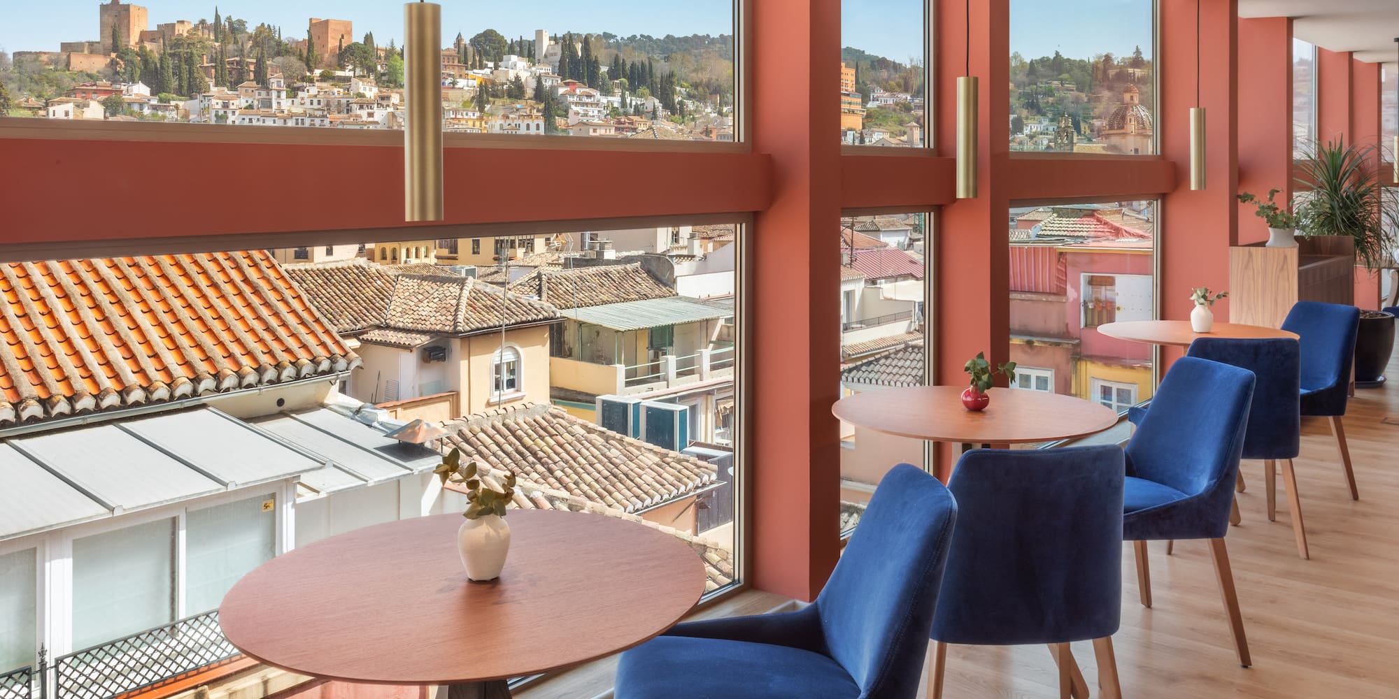 a room with tables and chairs and a view of a city