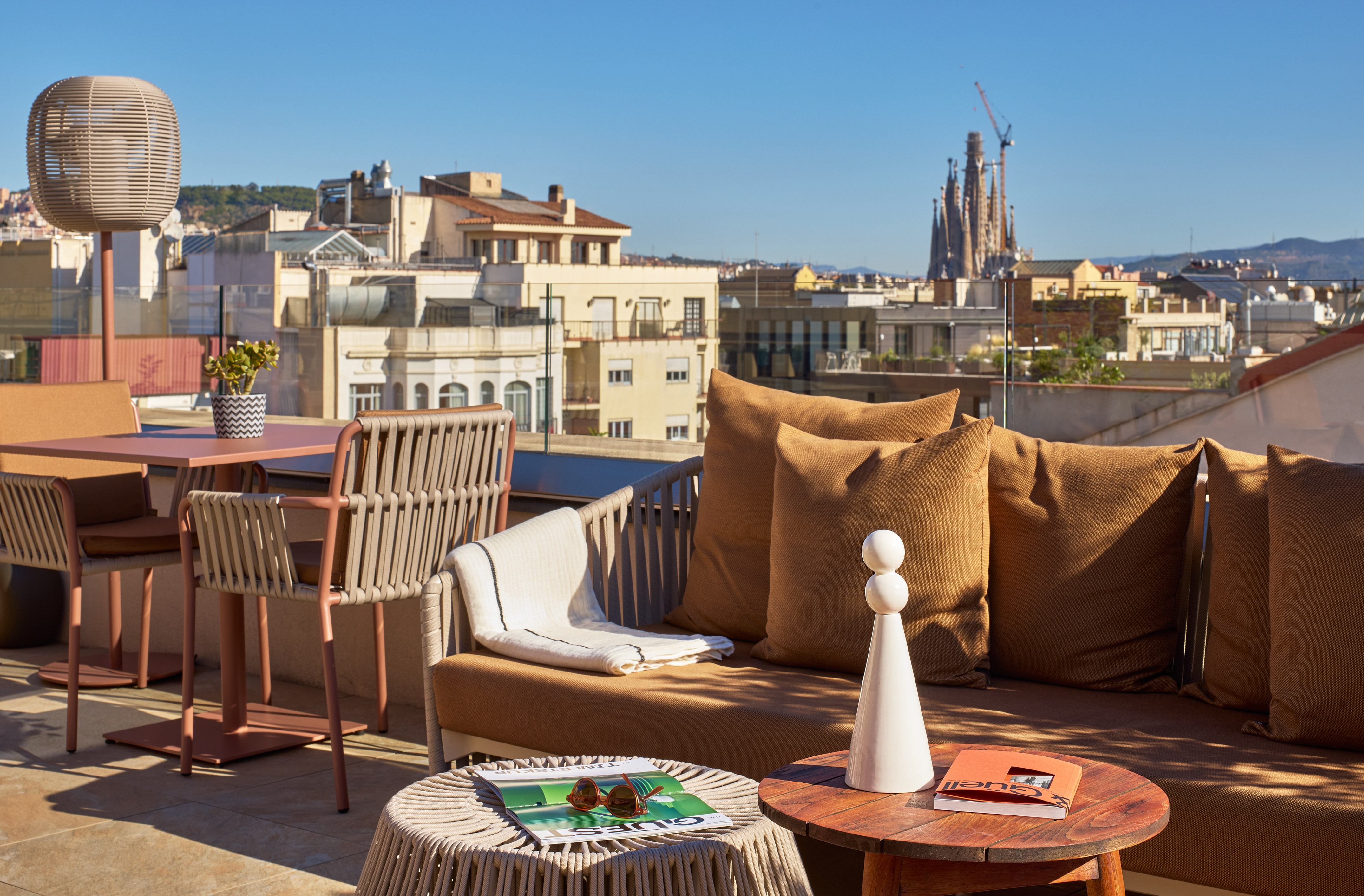 Barcelona rooftop terrace with outdoor lounge and Sagrada Familia view.