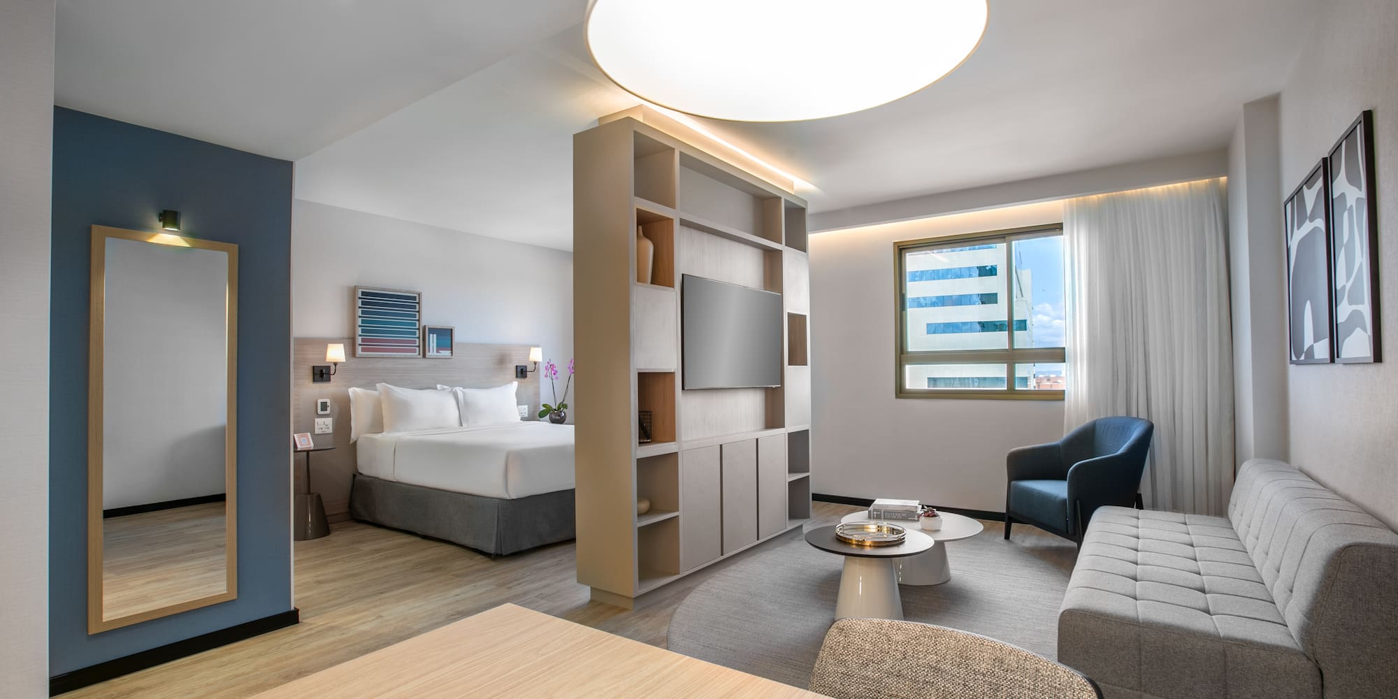 a room with a bed and a tv