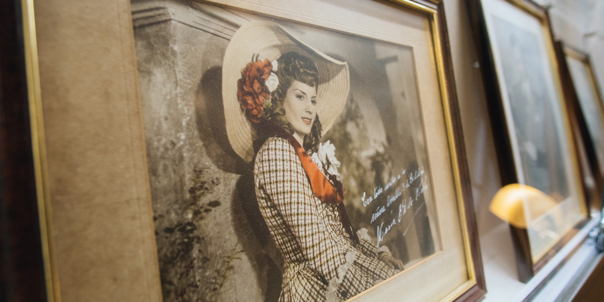 a framed picture of a woman in a hat