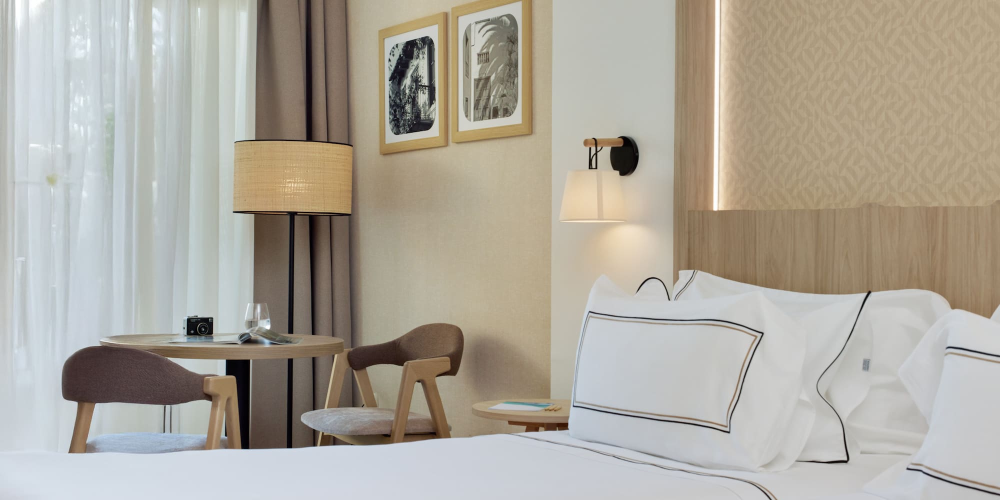 a hotel room with a bed and chairs