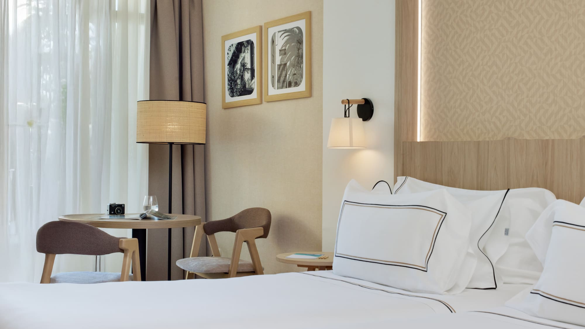 a hotel room with a bed and chairs