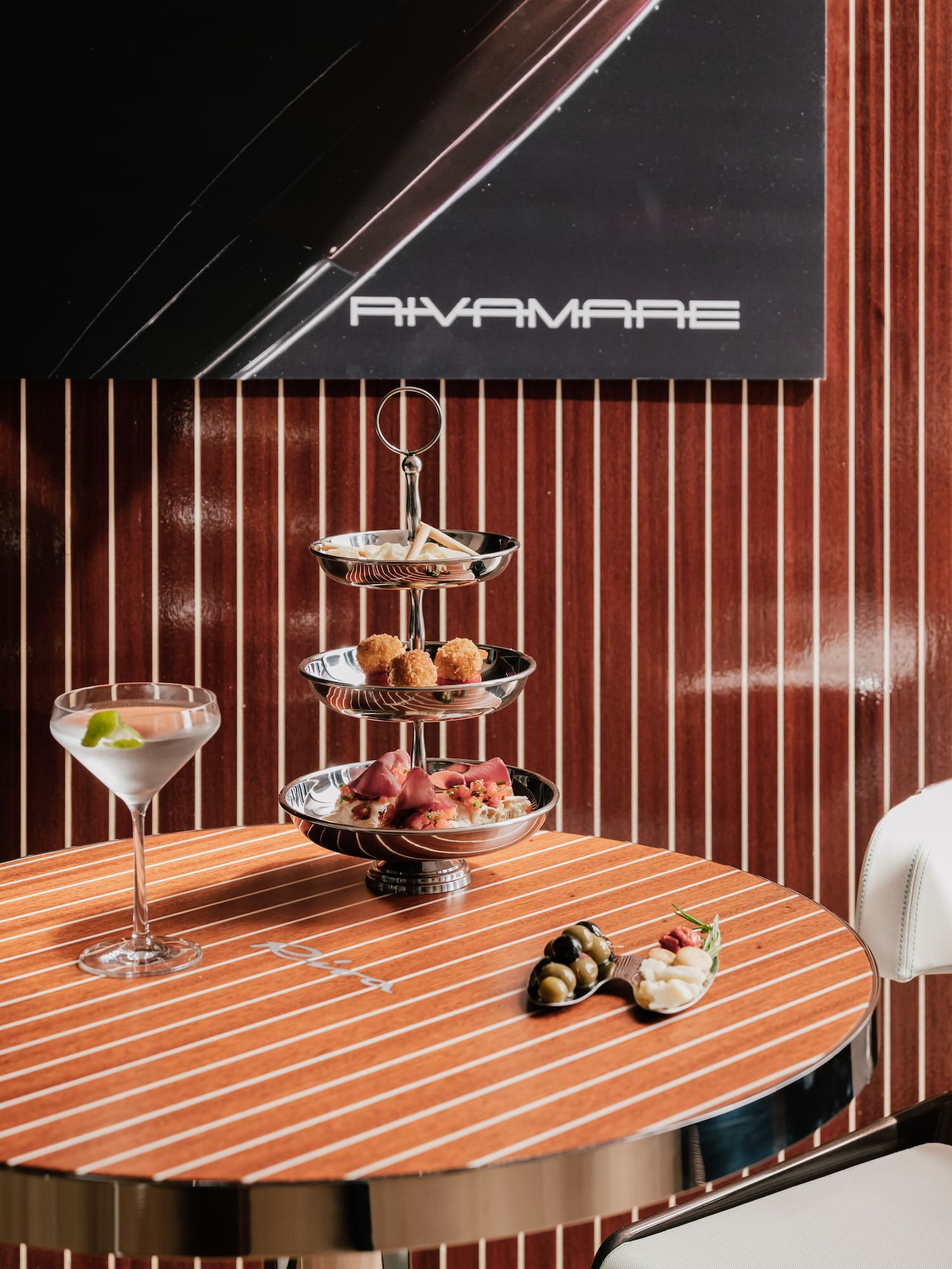 a three tiered tray with food on a table