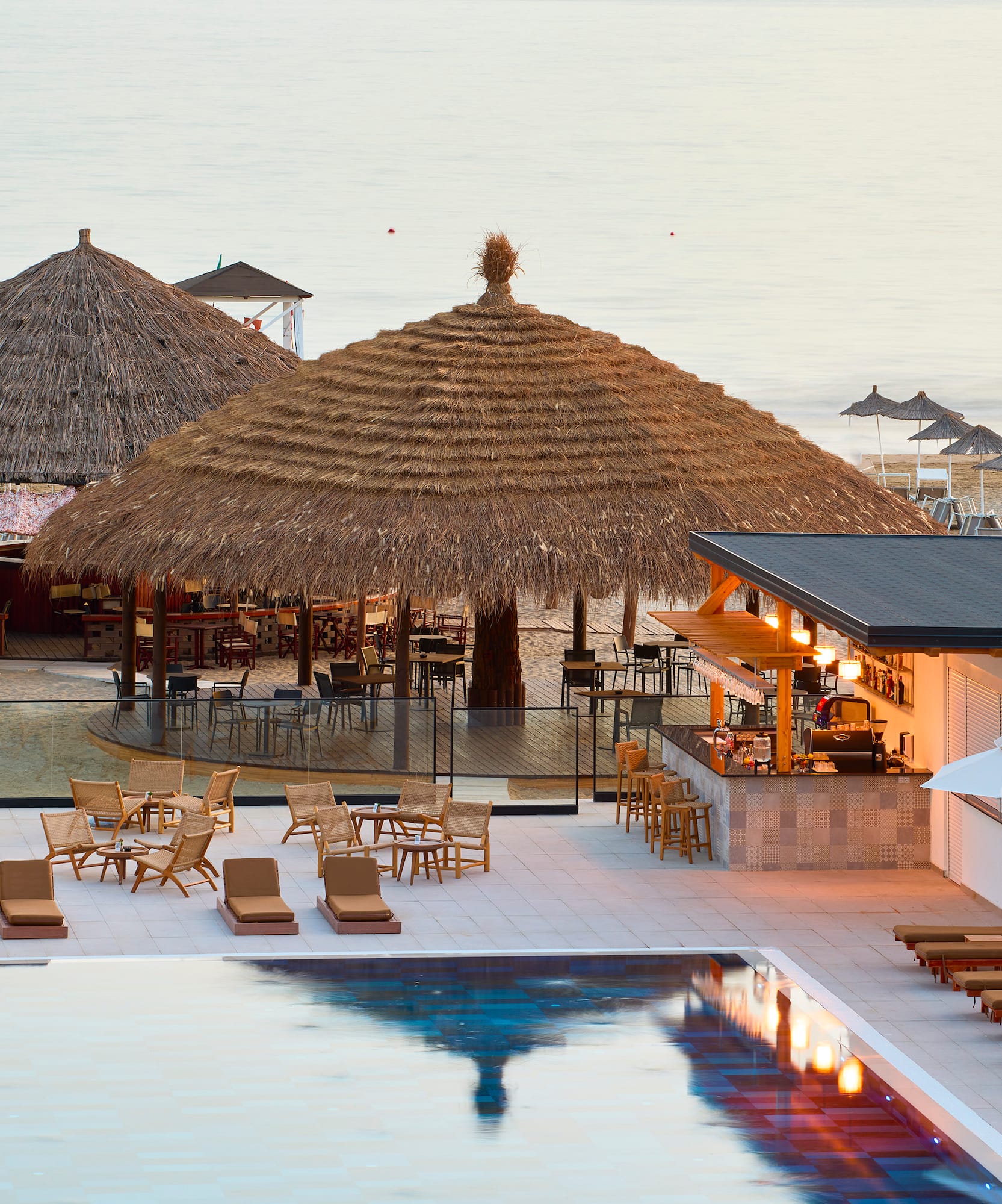 a pool with lounge chairs and umbrellas