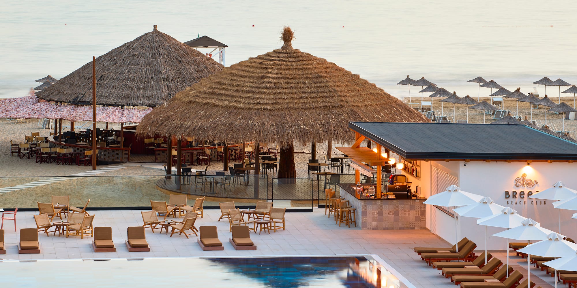 a pool with lounge chairs and umbrellas