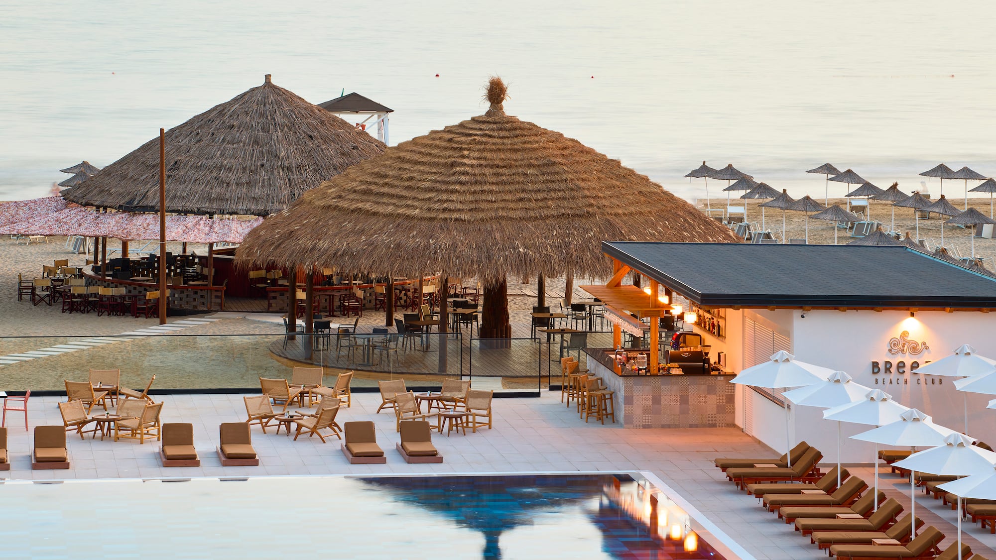 a pool with lounge chairs and umbrellas
