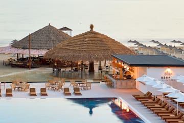 a pool with lounge chairs and umbrellas