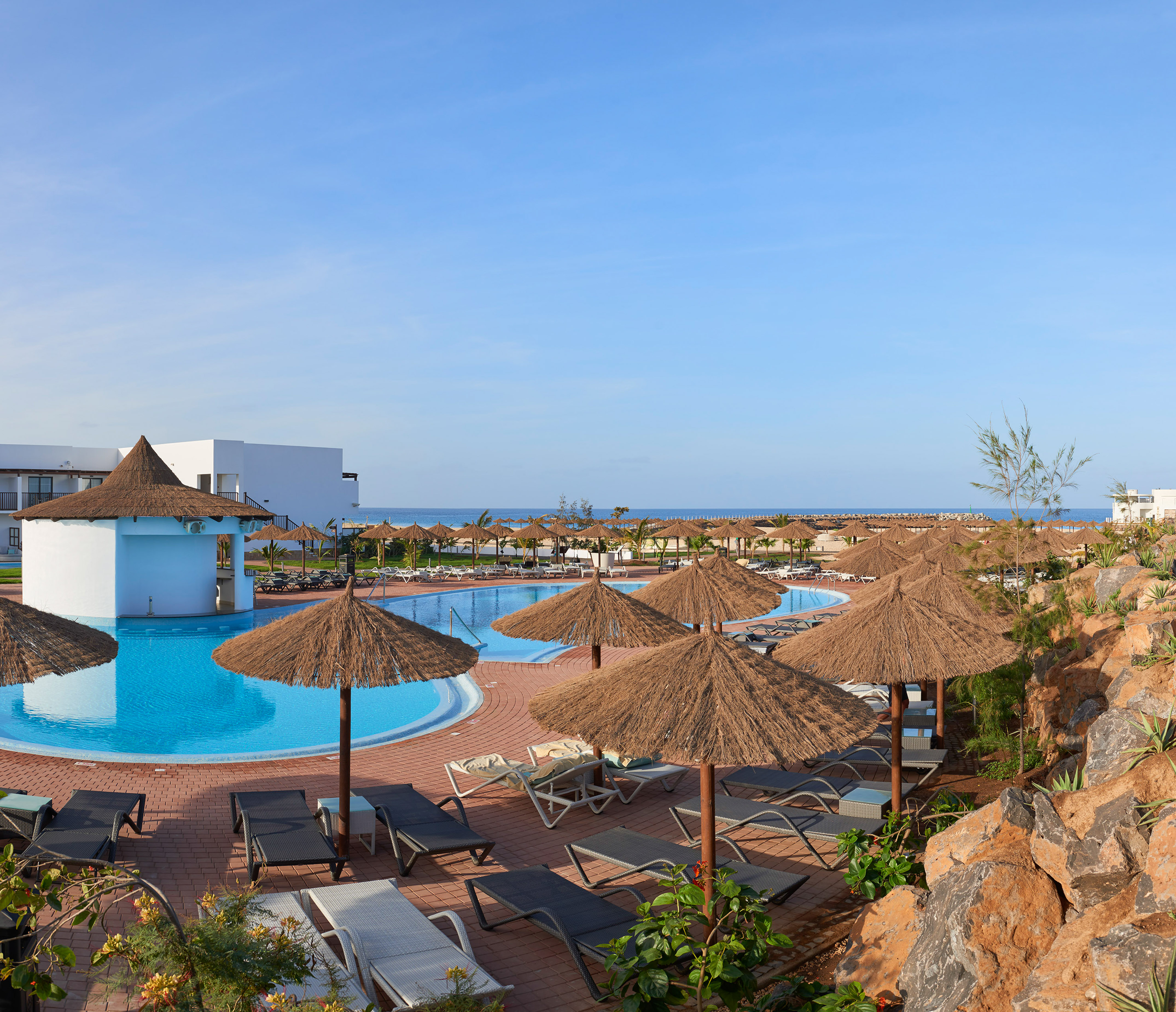 a pool with umbrellas and chairs