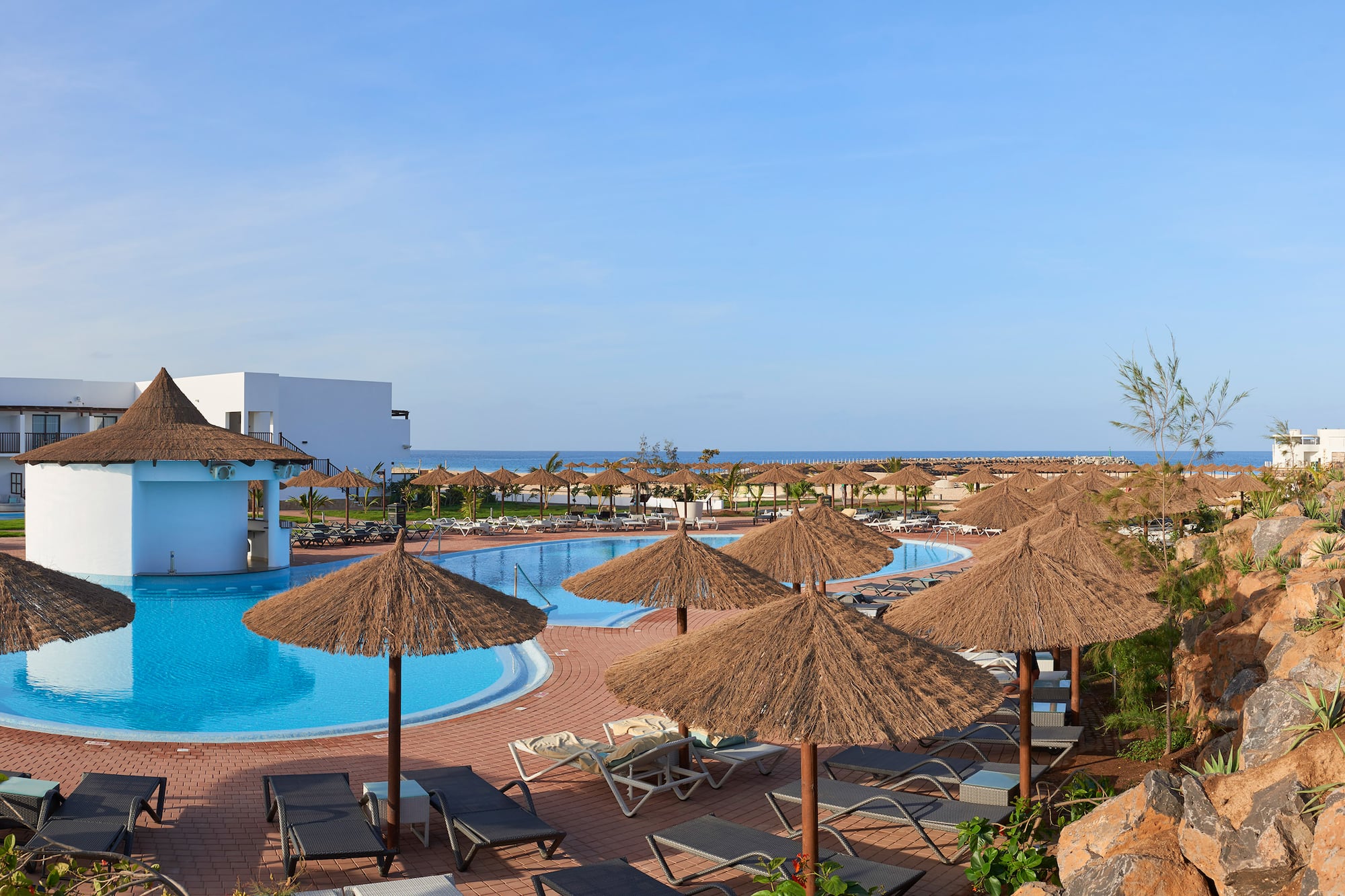 a pool with umbrellas and chairs