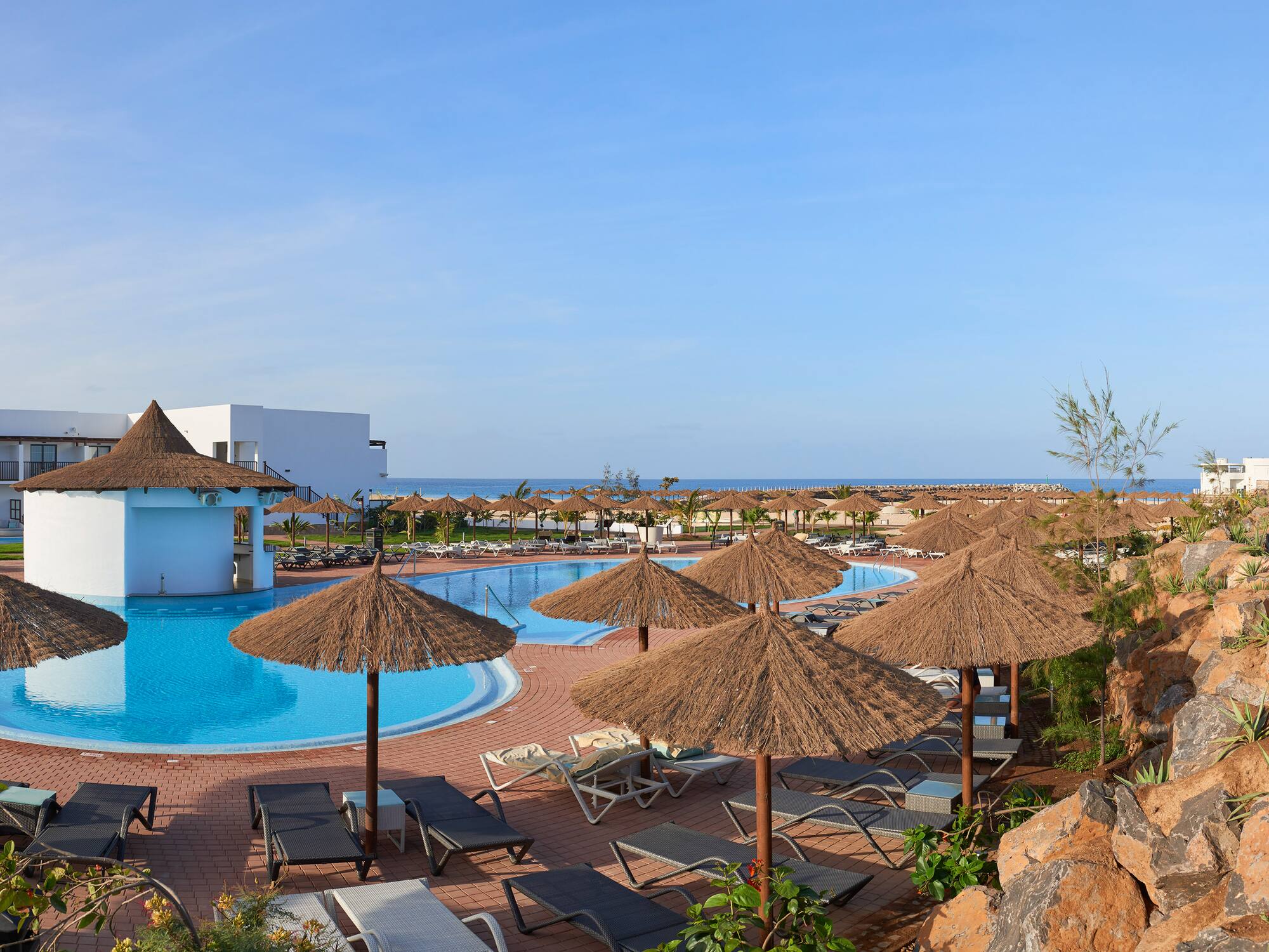 a pool with umbrellas and chairs