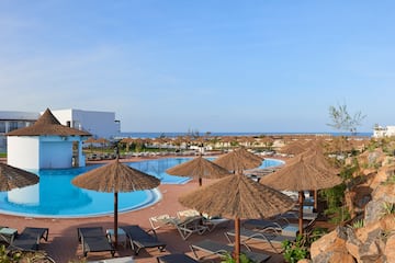 a pool with umbrellas and chairs